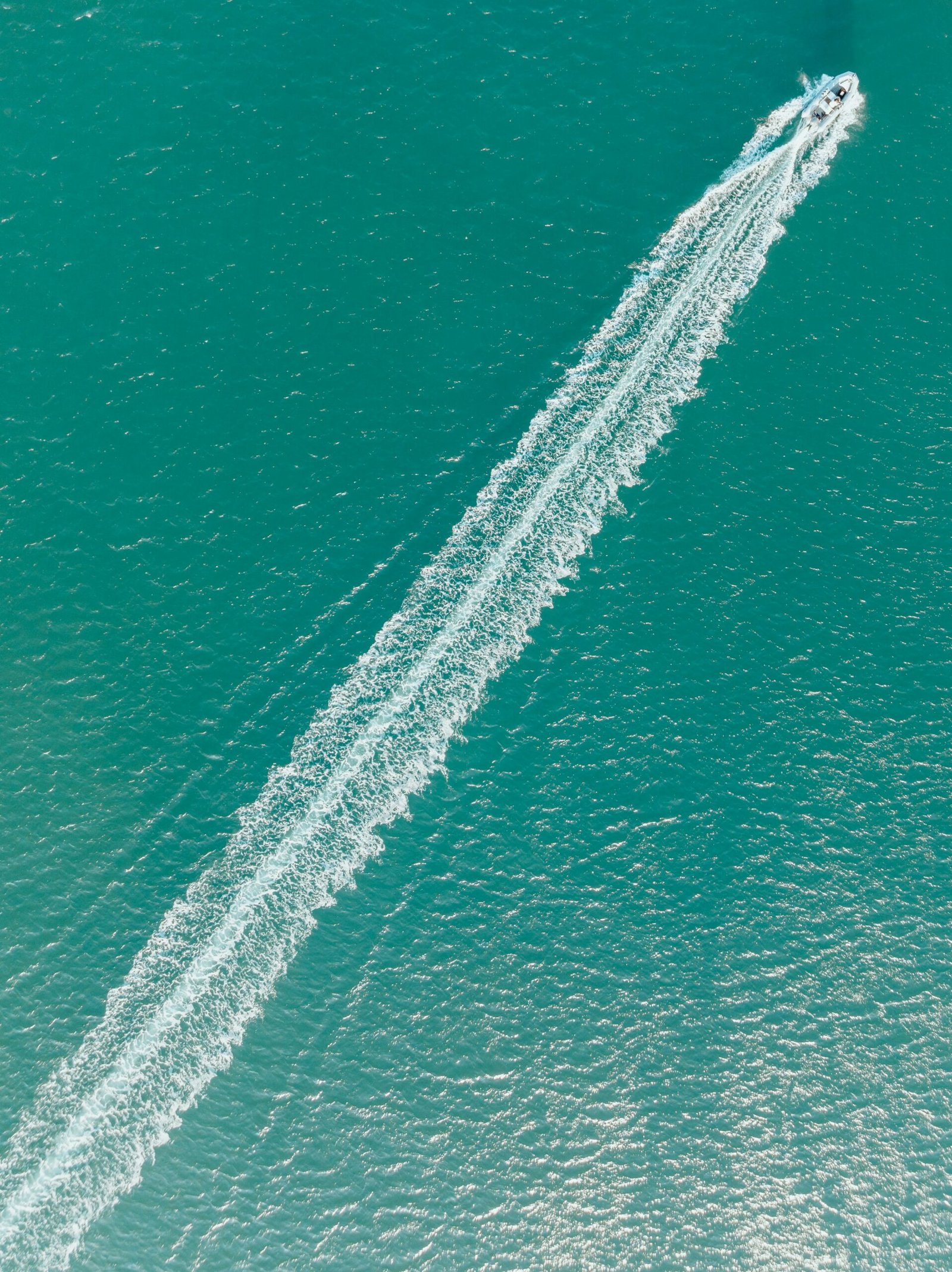 Blue coastal water and boats in Baja California Sur, Mexico.