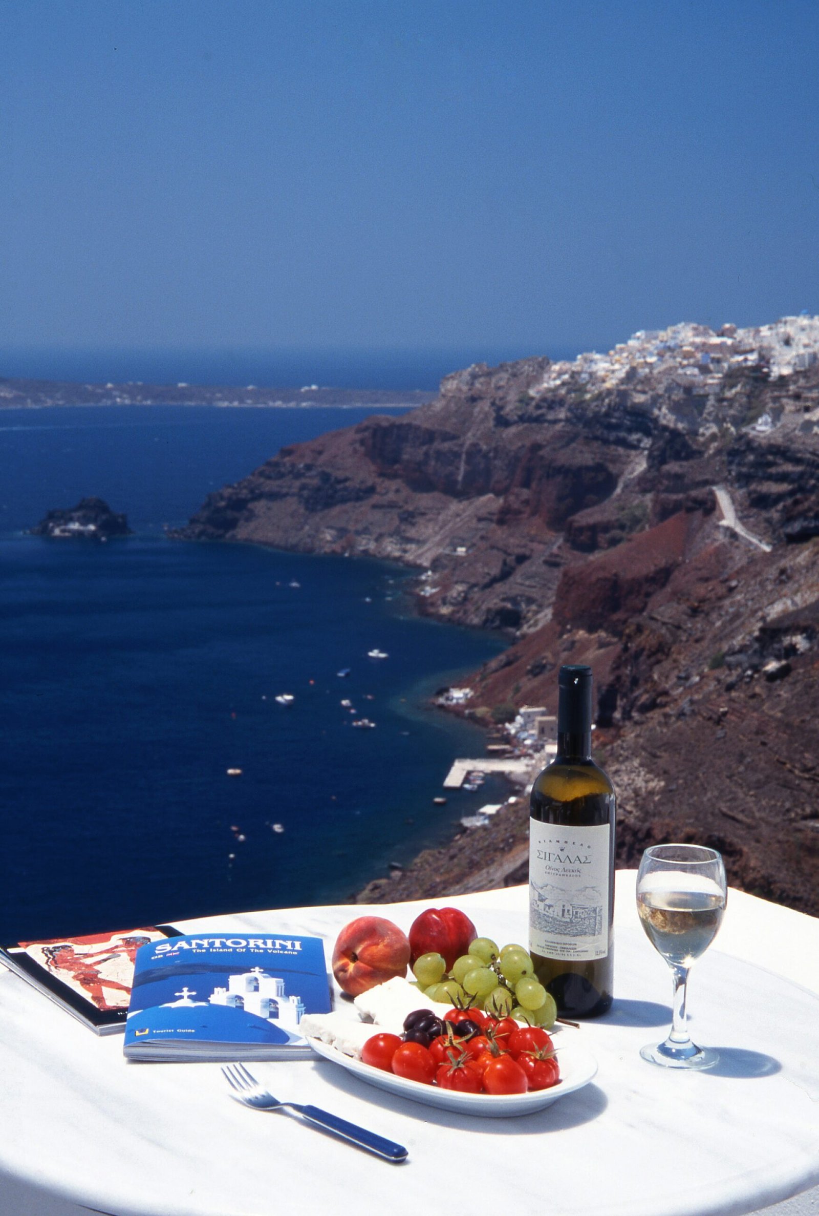 view of a table ready with food, in a restaurant facing the greek sea