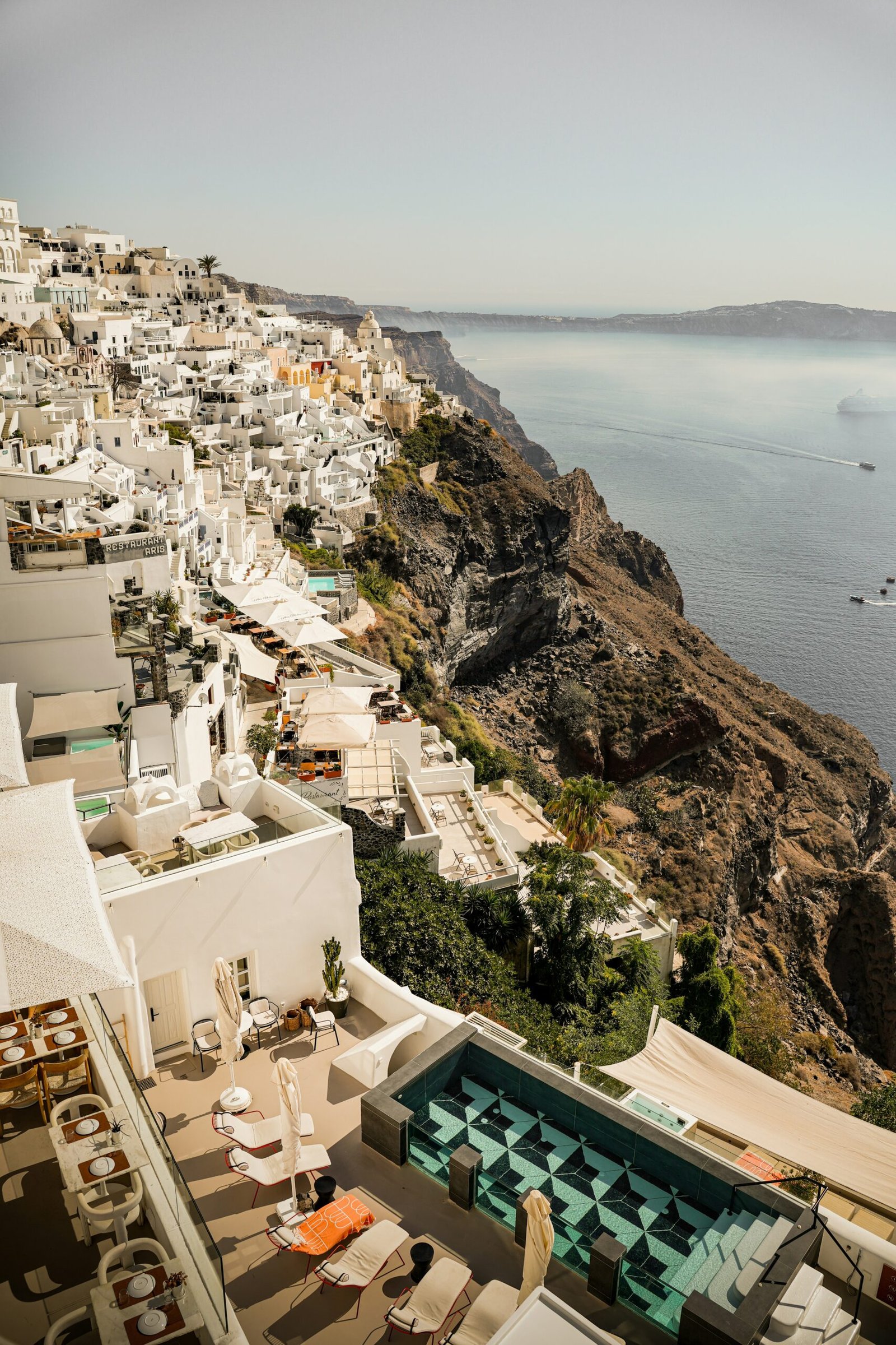 White cliffside homes in Oia, Santorini, bringing a radiant island atmosphere to a July yoga retreat.