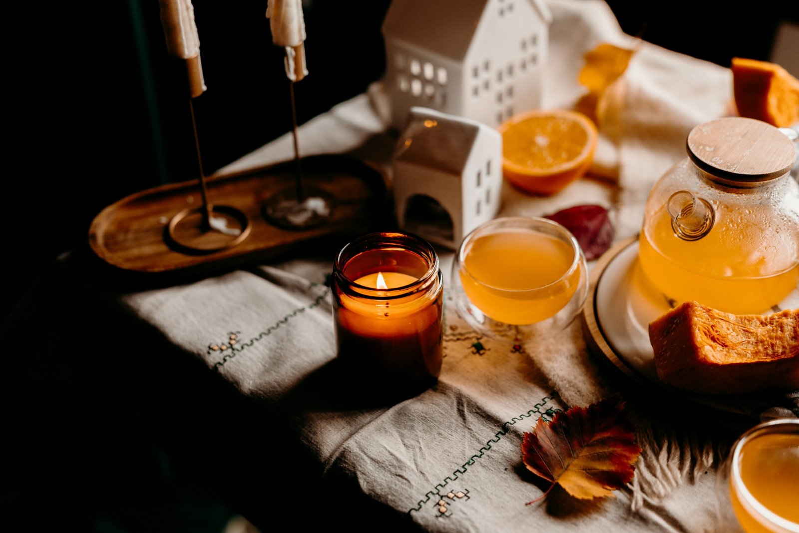 Cozy tea and candle setup that captures the warm and reflective mood of a November retreat