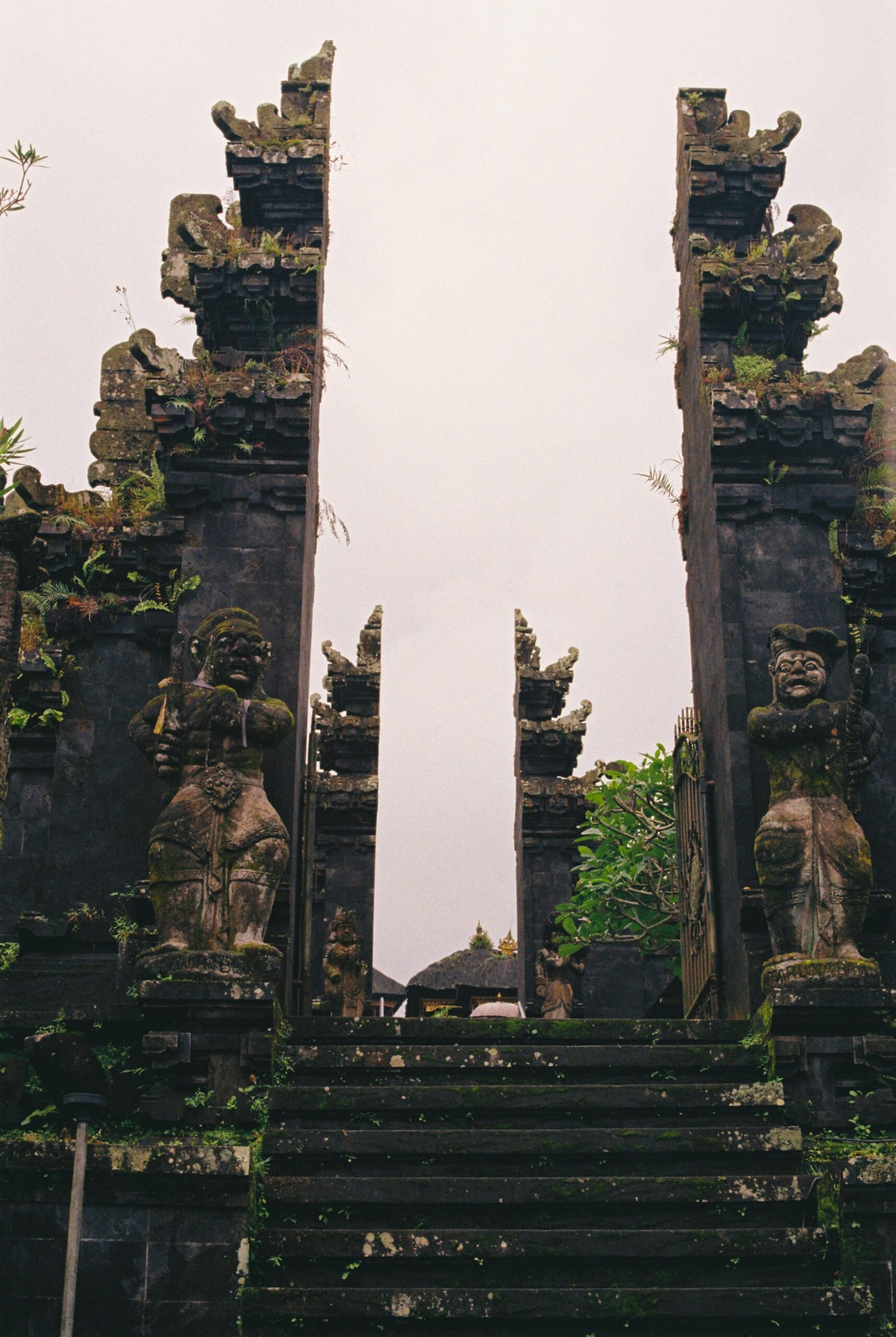 stone gate at besakih temple with carved detail and mountain light
