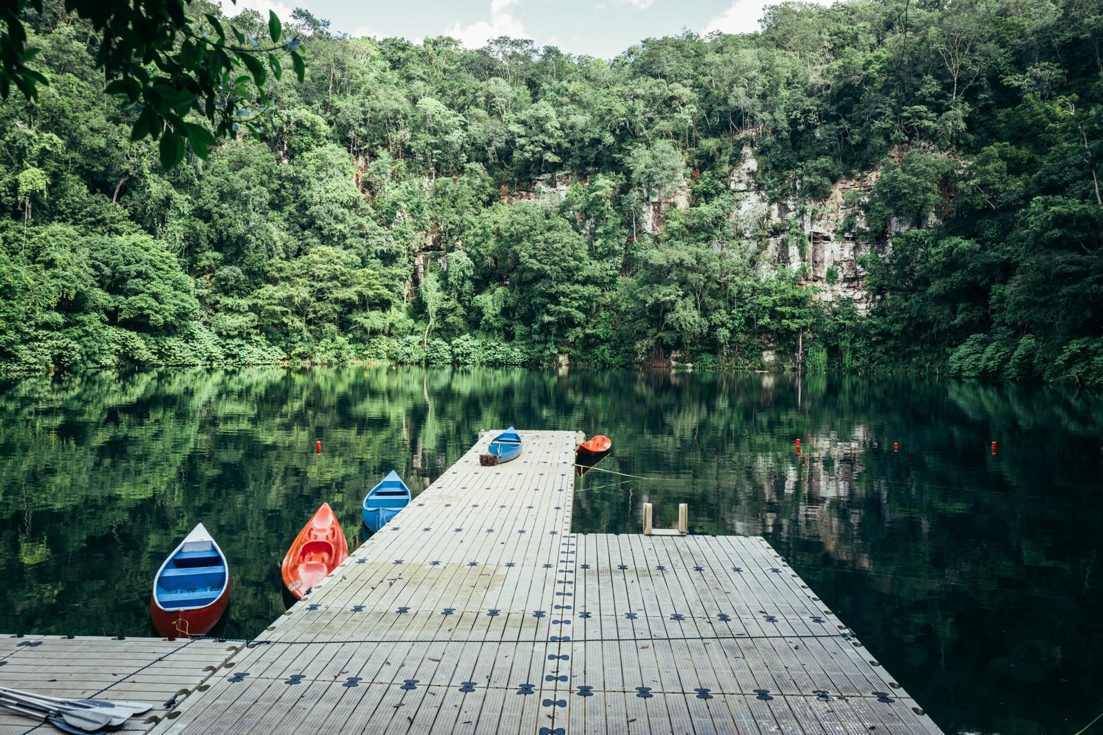 Turquoise cenote in Valladolid surrounded by jungle for a refreshing Mexico wellness escape
