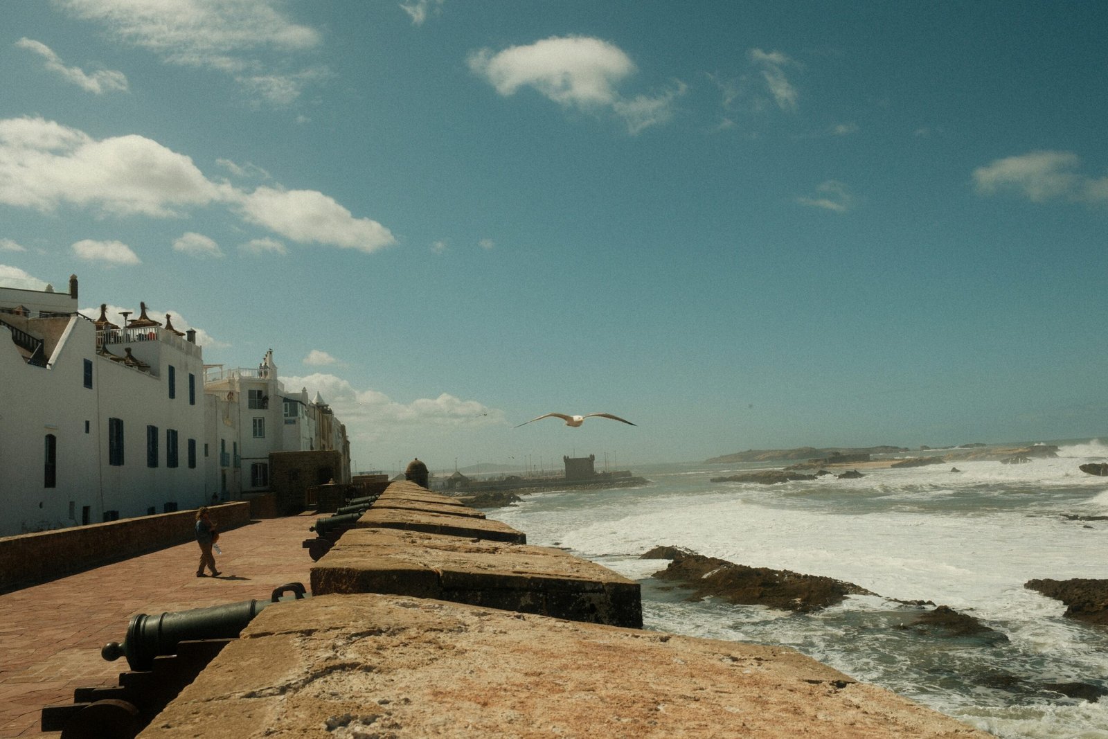 atlantic waves striking the essaouira ramparts during a breezy june retreat