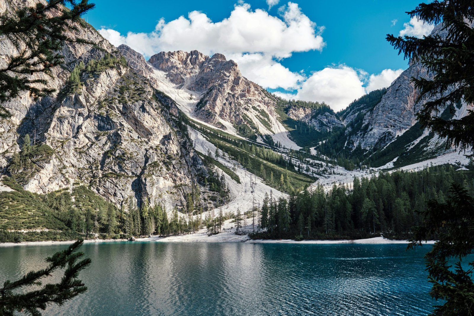 Lago di Braies in South Tyrol with forested slopes and reflective water suited to a grounding retreat theme.