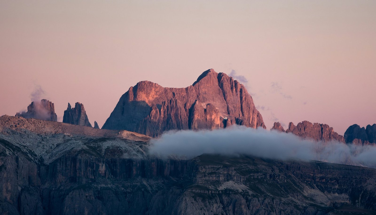 Spring light over the Dolomites near Bolzano with sharp alpine peaks and a fresh seasonal glow.
