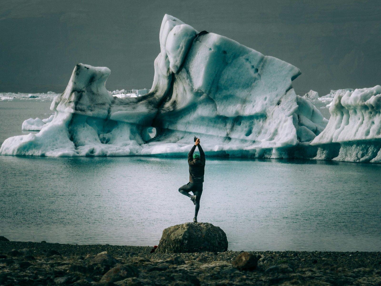 yoga pose in front of an iceberg