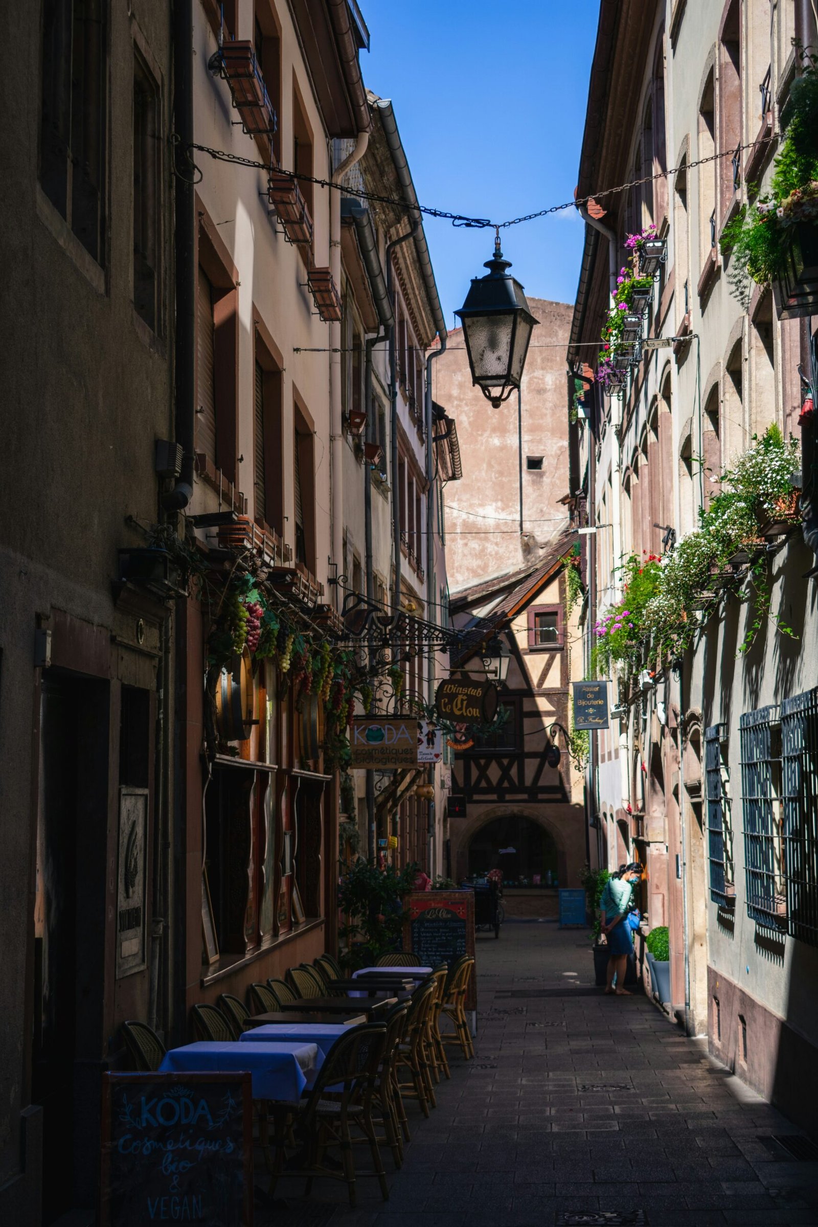 People walking through a narrow street in Strasbourg, bringing a relaxed and scenic local feel to a France yoga retreat.