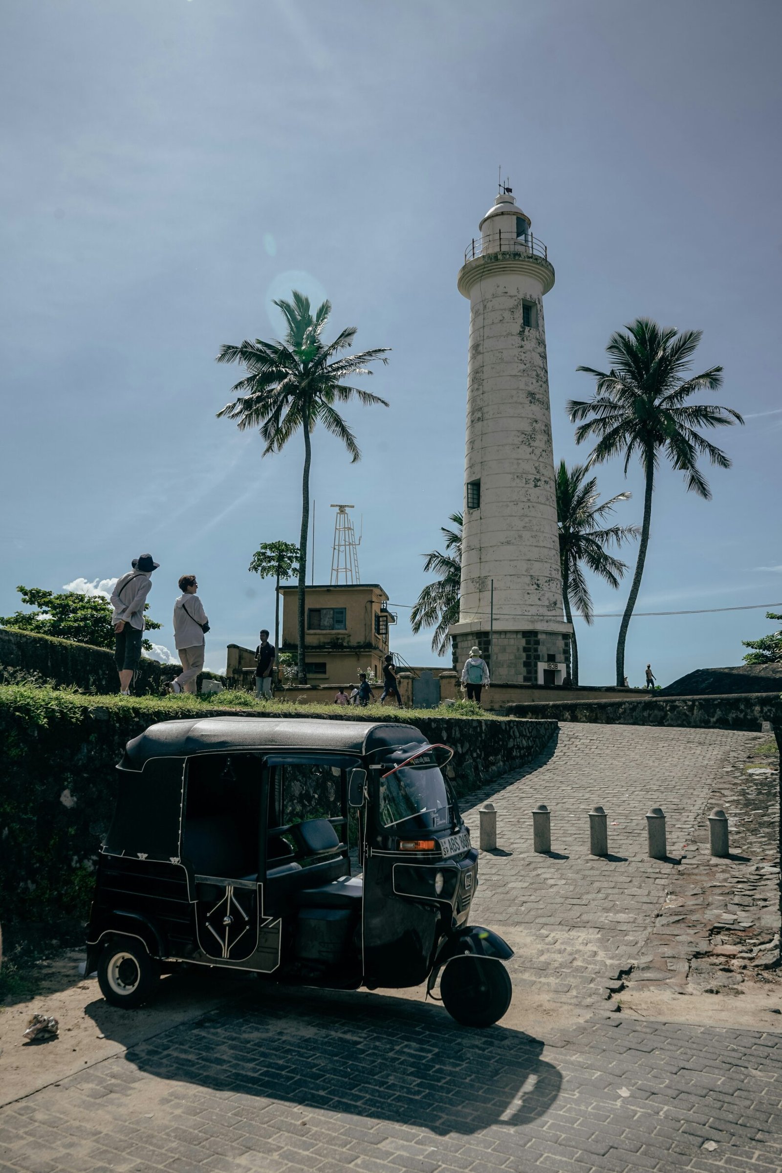 Tuk tuk beside the lighthouse at Galle Fort in Sri Lanka, reflecting the cultural depth of a September retreat itinerary.