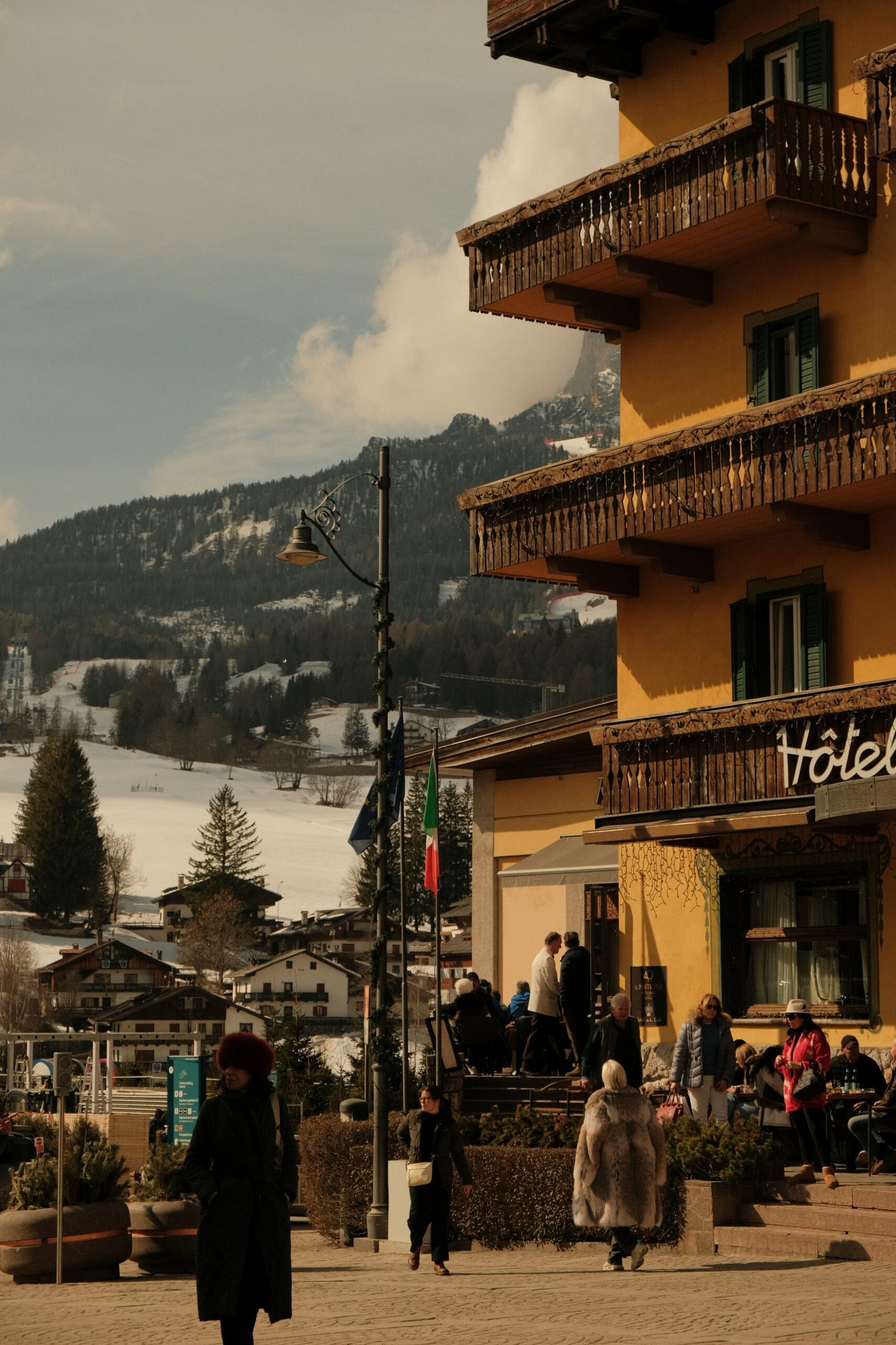 Yellow mountain retreat hotel with balconies and snowy peaks creating a restorative winter wellness setting