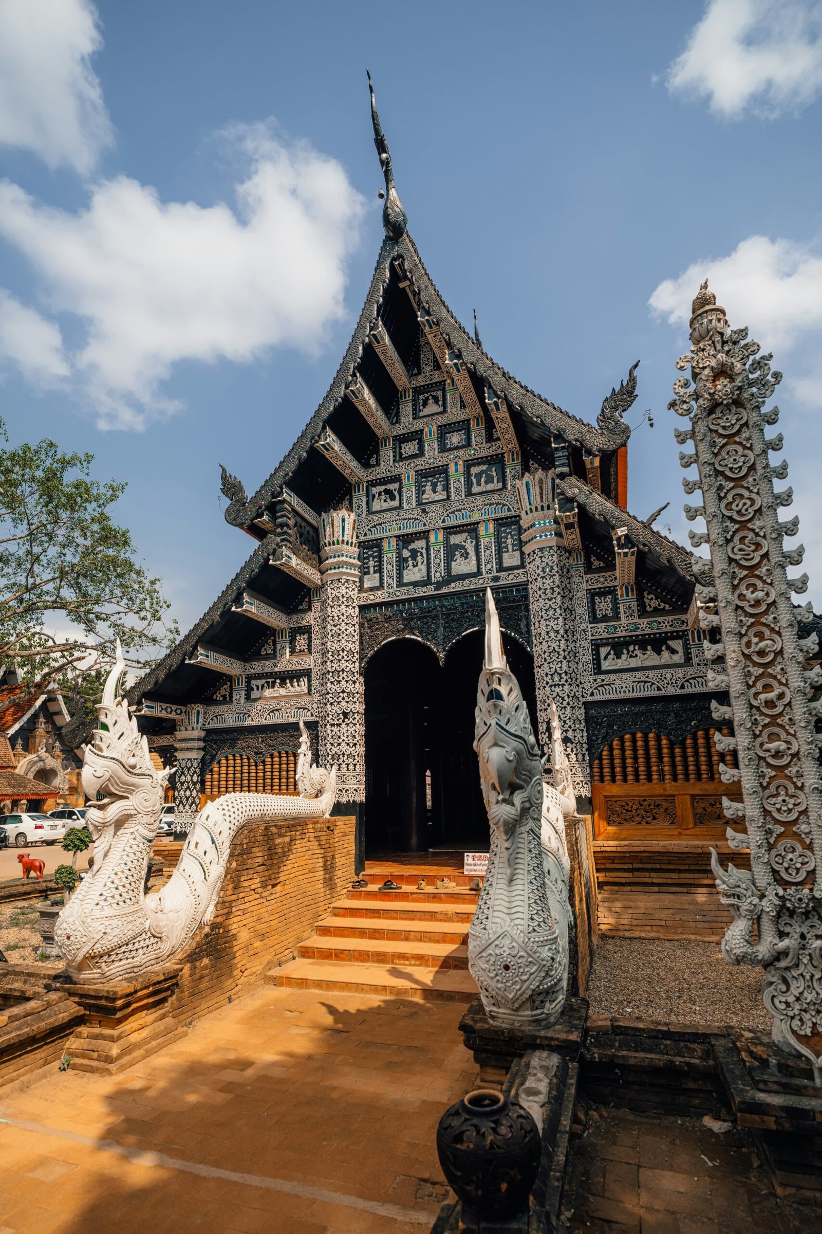 Ornate temple in Chiang Mai under a blue sky reflecting the cultural side of a Thailand winter retreat