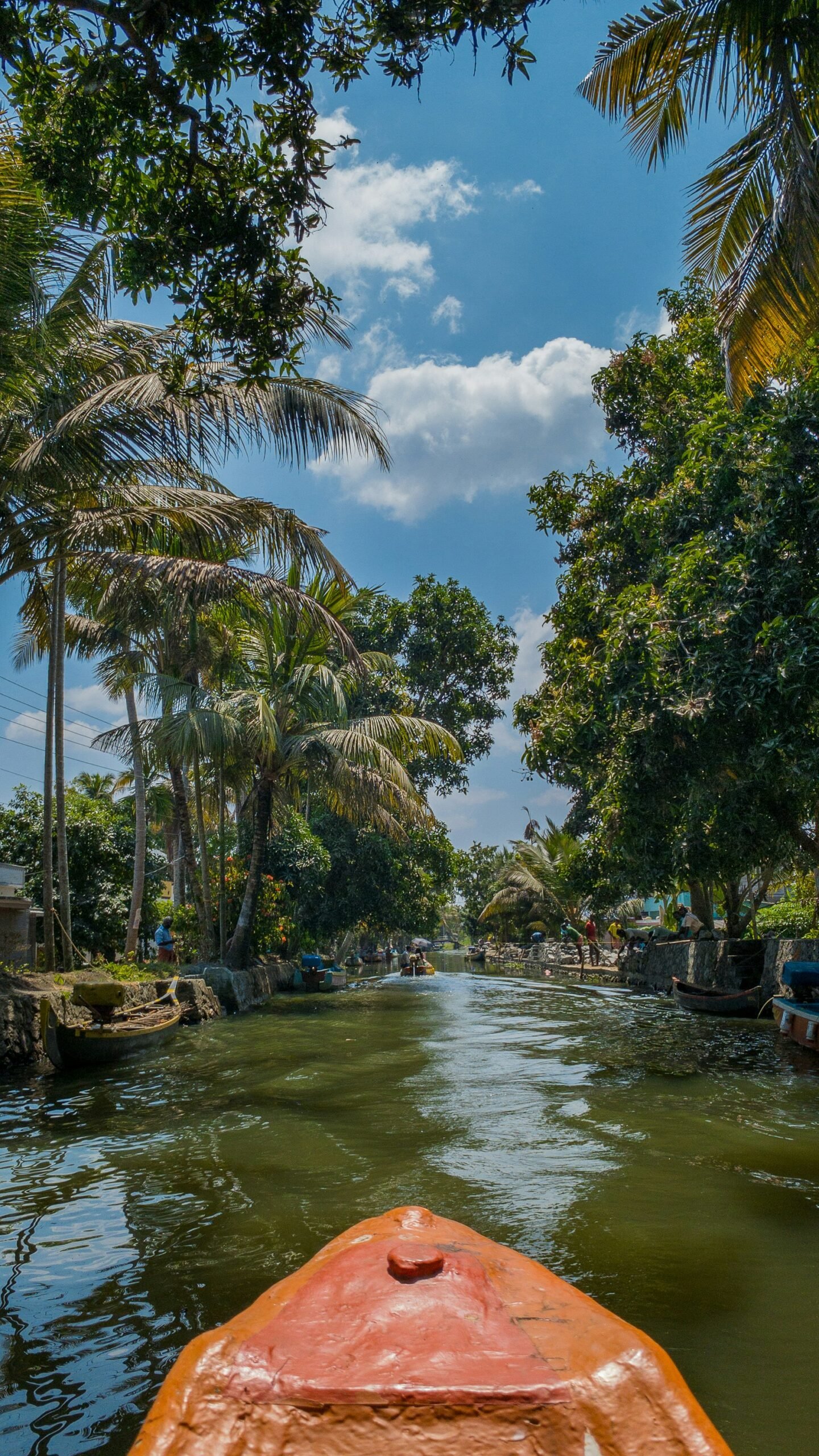 Boat moving through the Alappuzha backwaters, evoking the calm and restorative rhythm of a September retreat in Kerala.