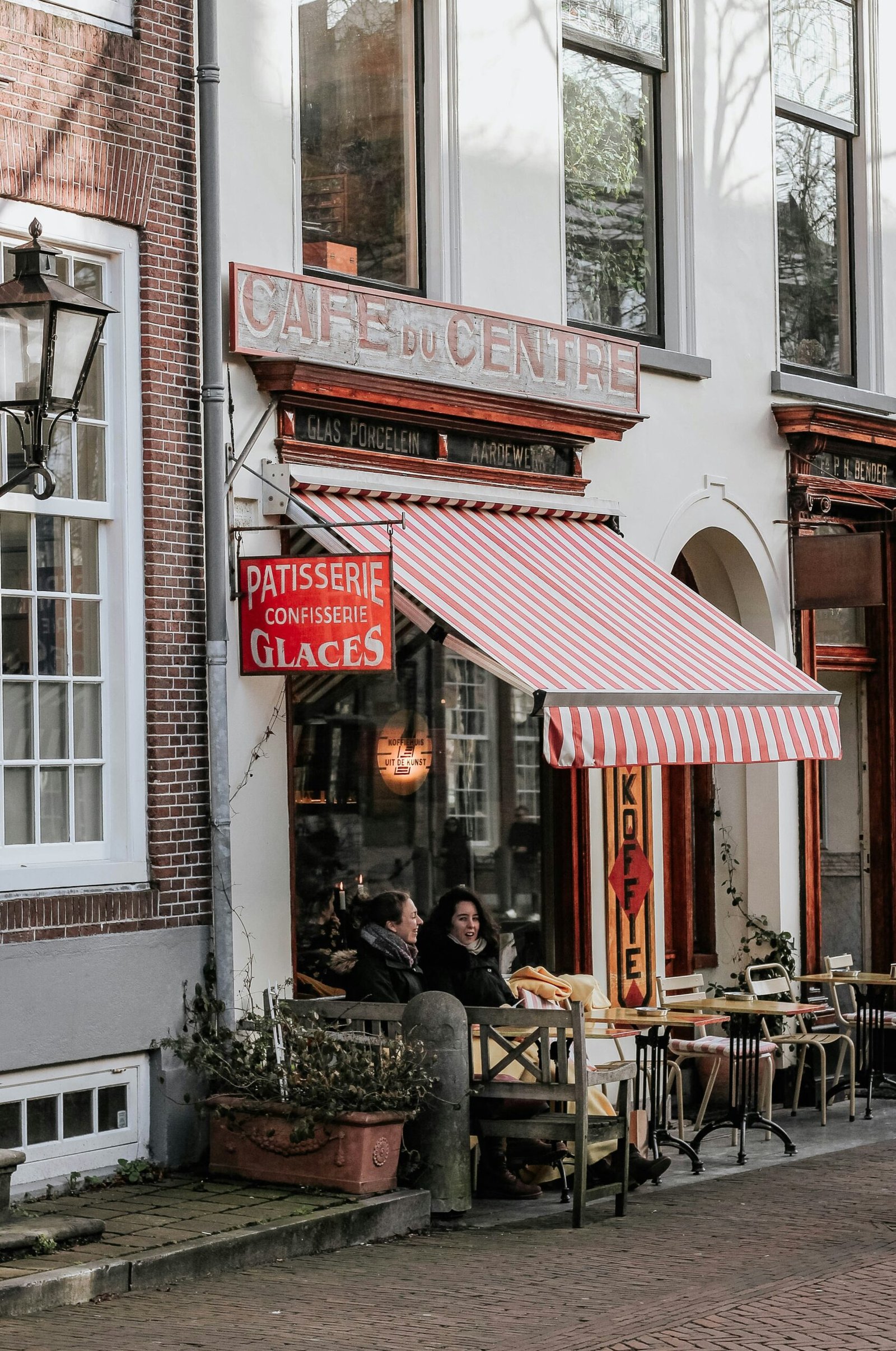 Outdoor cafe terrace in Delft with a relaxed European atmosphere, matching the slow and social moments of a France yoga retreat.