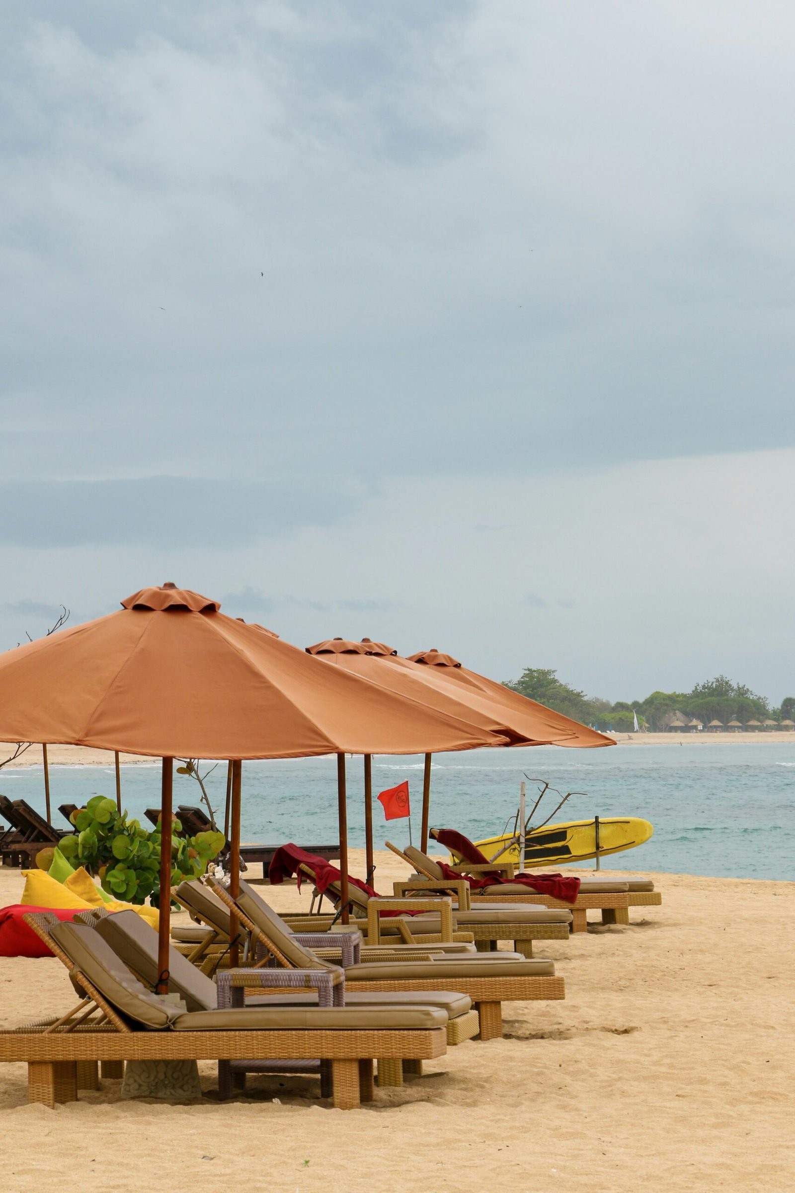 Beach chairs and umbrellas set along the shore for a peaceful retreat day focused on calm and restoration