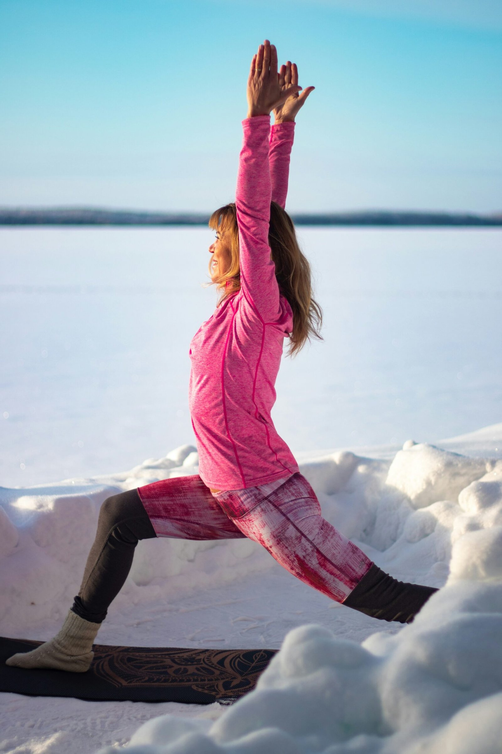 woman doing yoga in the snow