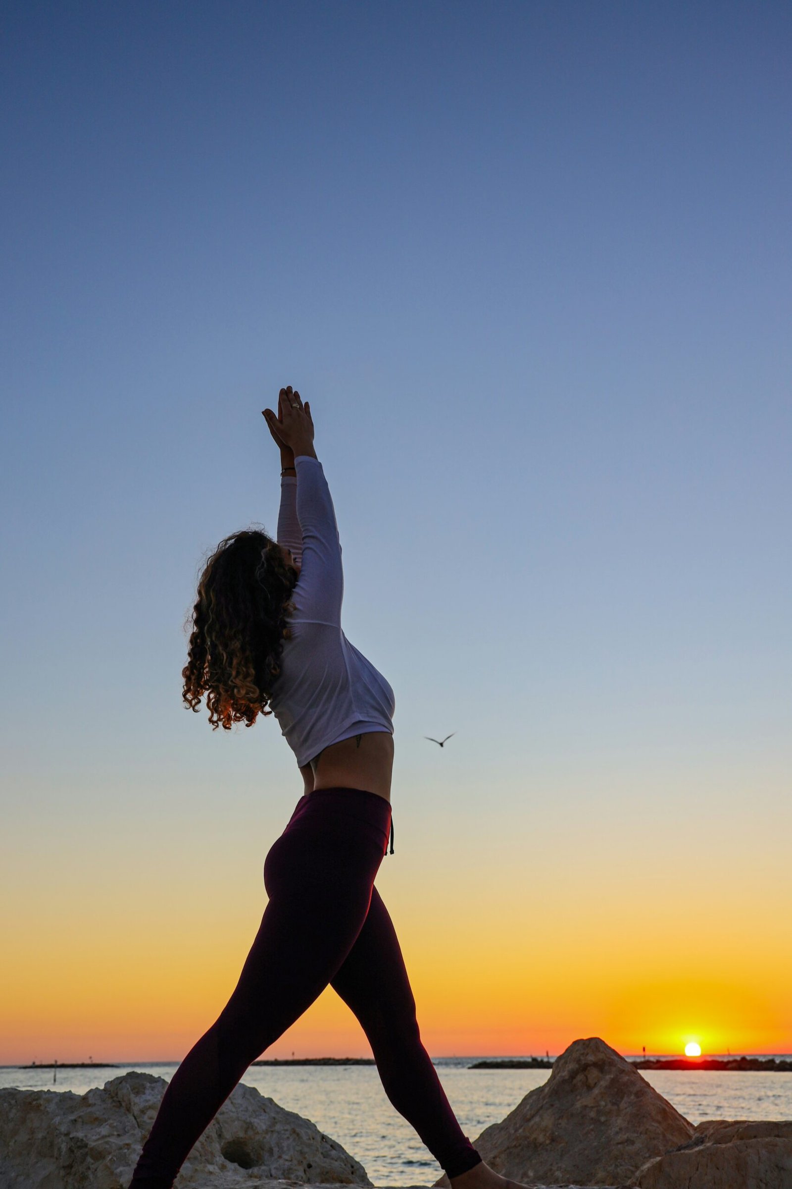 person practicing yoga at sunrise in palma spain
