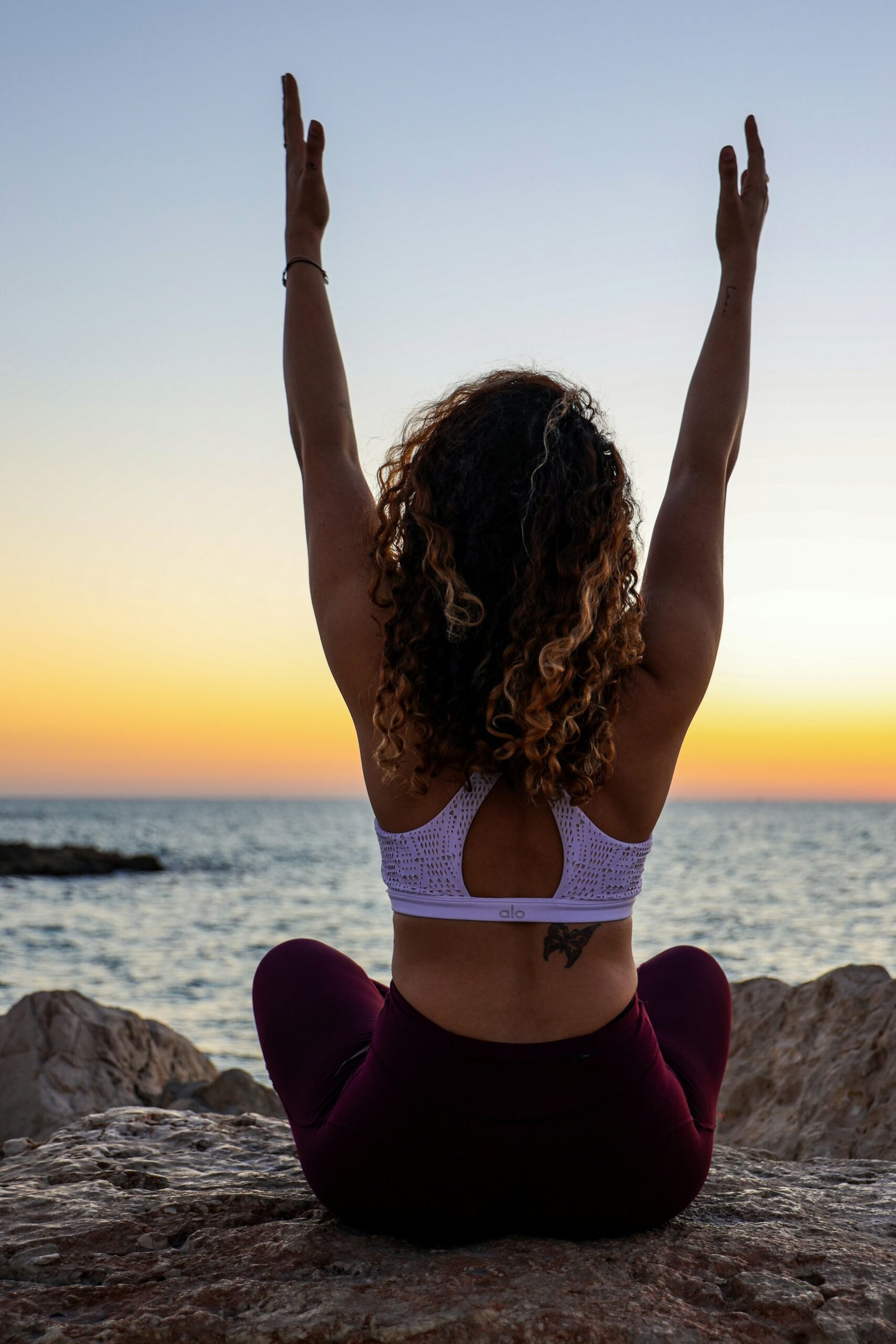 woman doing yoga in february, in a yoga retreat on the coast for maxumum relax