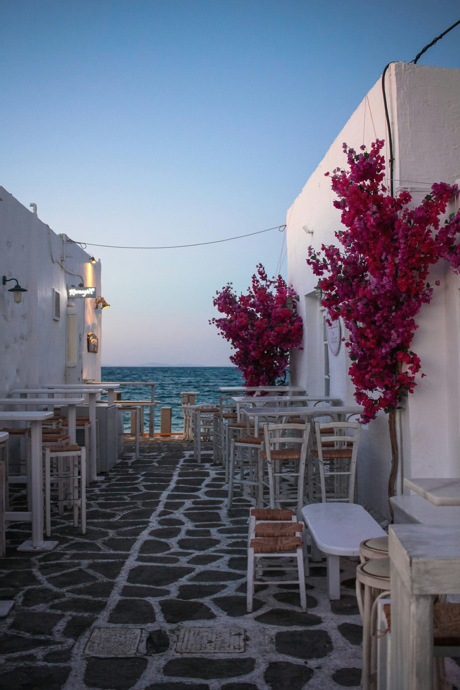 White seaside table and chairs in Naoussa, Paros, adding a calm and welcoming detail to a peaceful Greek retreat stay.