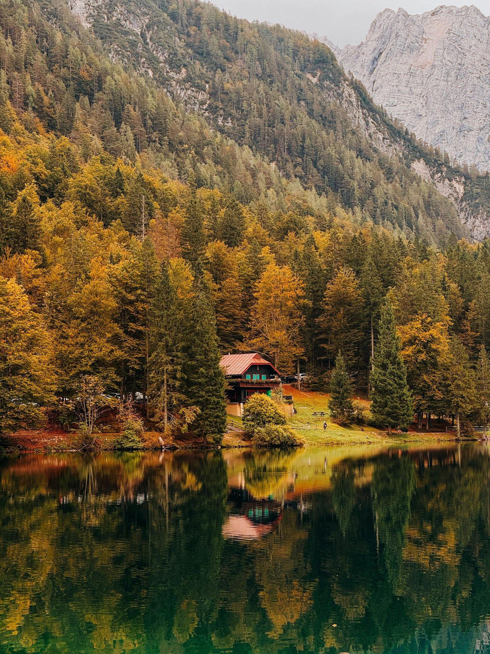 Cabin beside a lake in an autumn forest for a peaceful October retreat stay