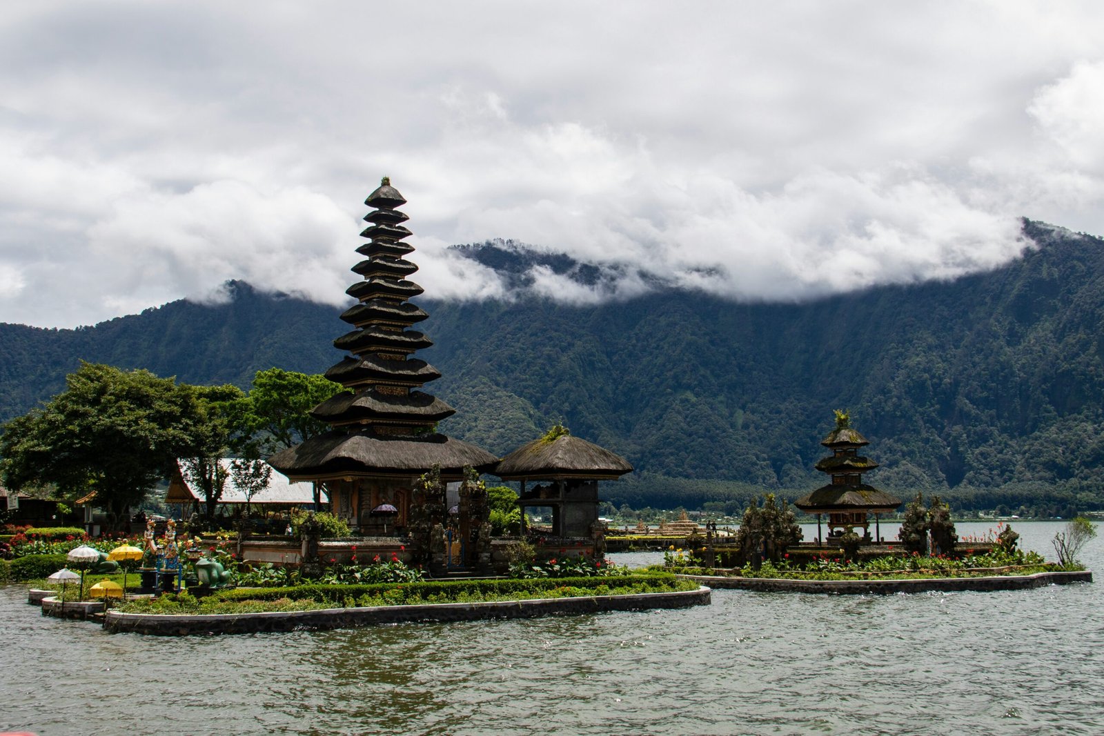 ulun danu bratan temple surrounded by moody skies and water in bali