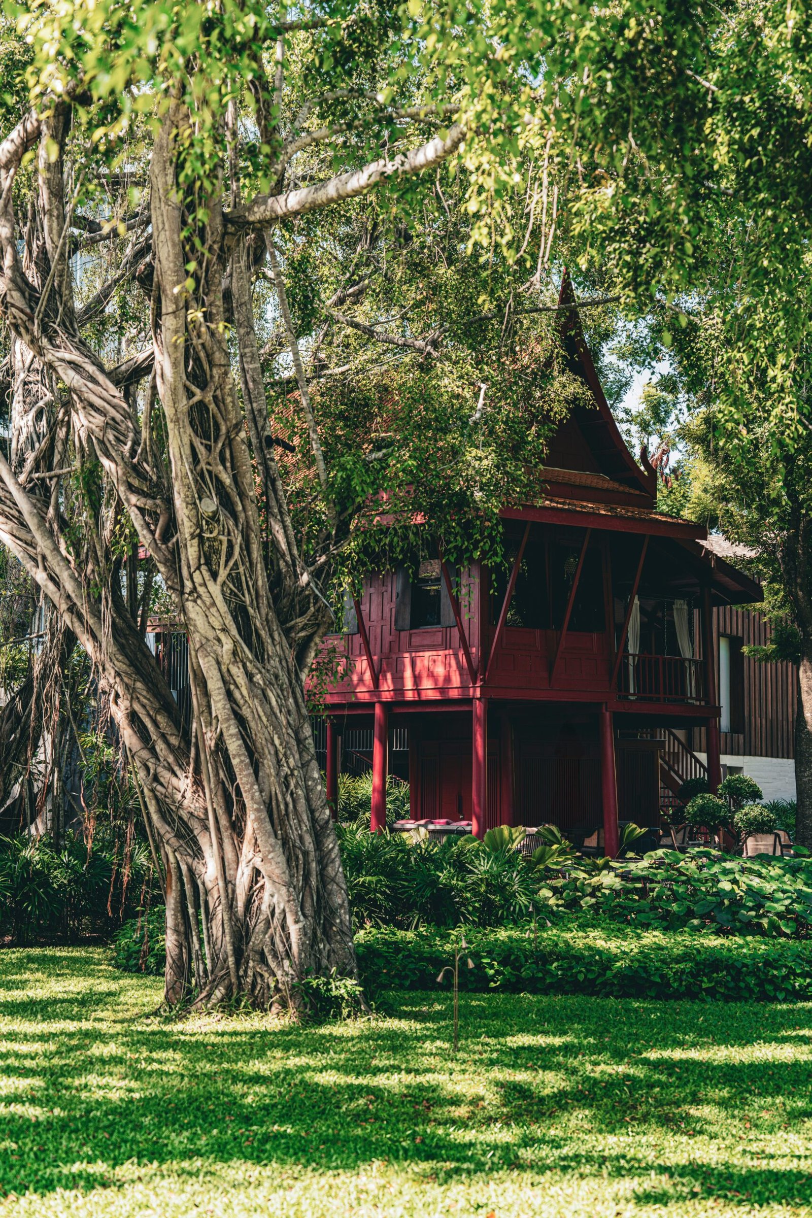 Red countryside retreat house set in a wide green field for a restful rural wellness getaway