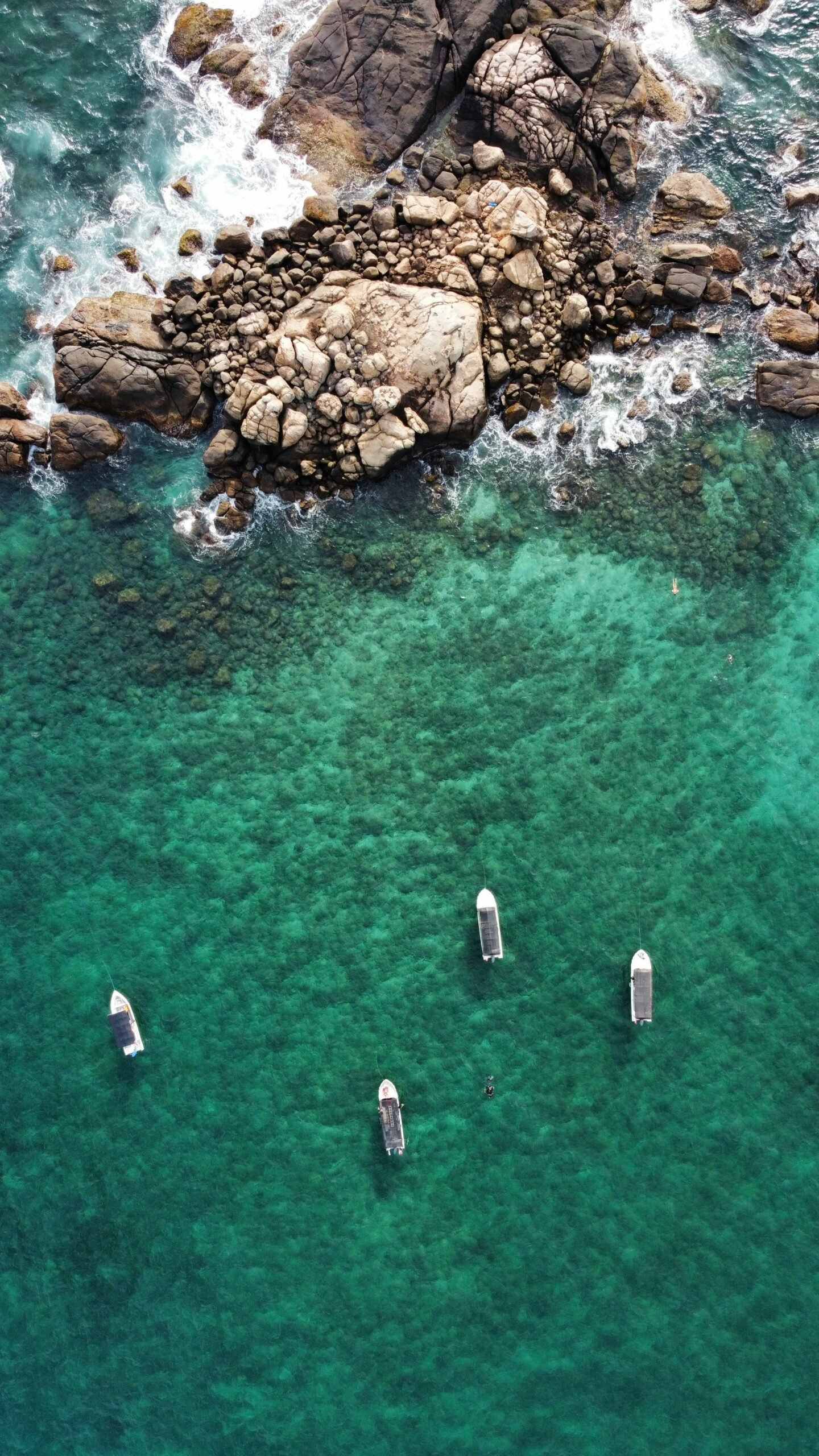 Traditional boats resting on the shoreline in Sri Lanka, bringing a calm coastal mood to a yoga retreat by the sea.