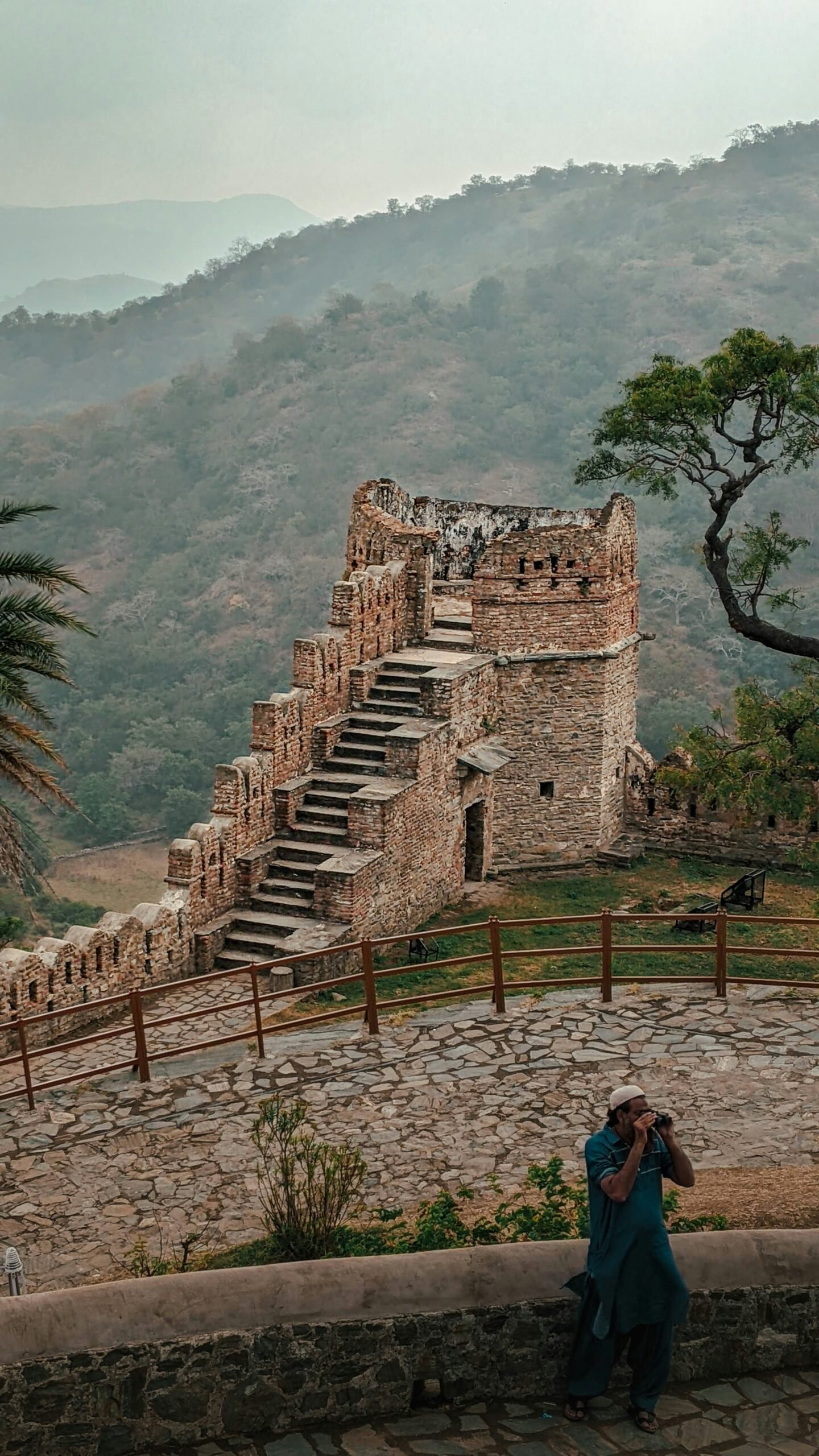 Traveler photographing Kumbhalgarh Fort in Rajasthan, adding a cultural and contemplative backdrop to a retreat-inspired journey in India.