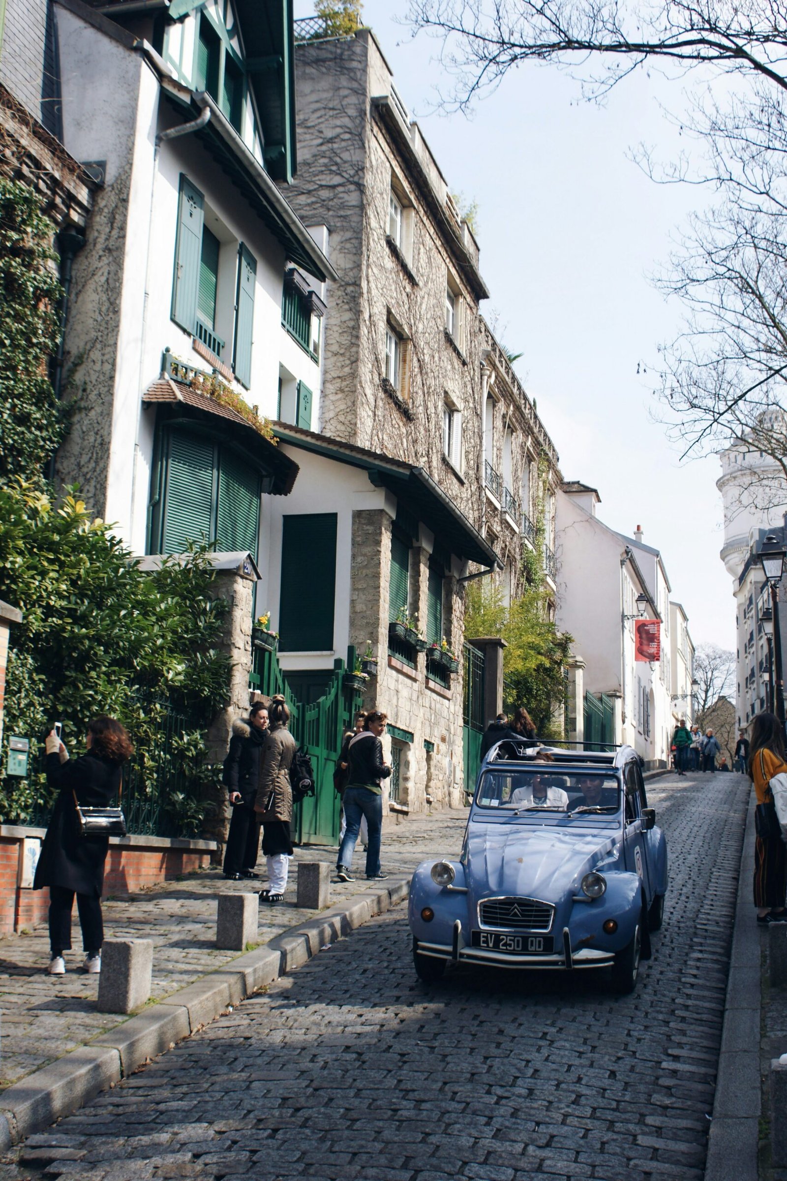 Vintage car on a Montmartre street in Paris, adding a charming and relaxed local feel to a France yoga retreat experience.