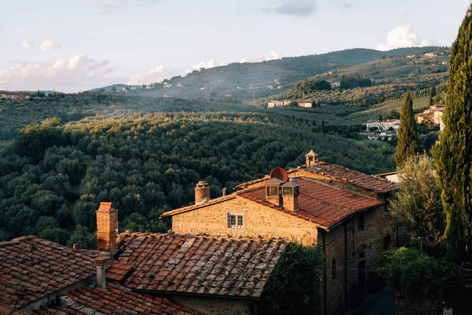 tuscan village with rolling hills and olive groves in italy for a peaceful wellness retreat
