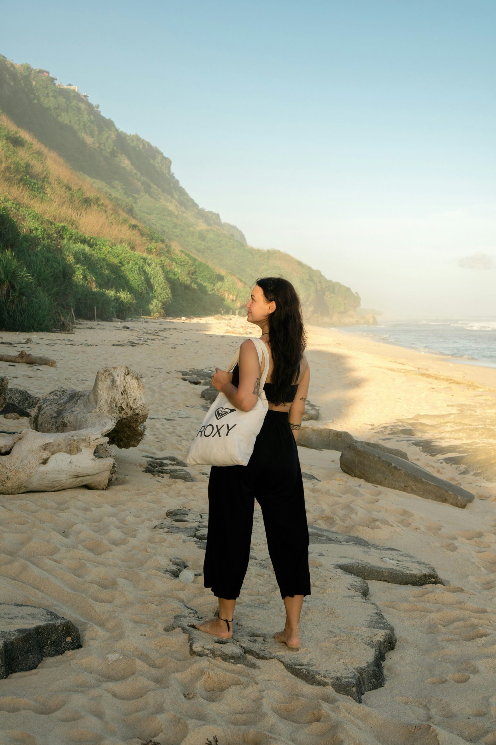 woman on a bali beach during the gentle transition into dry season