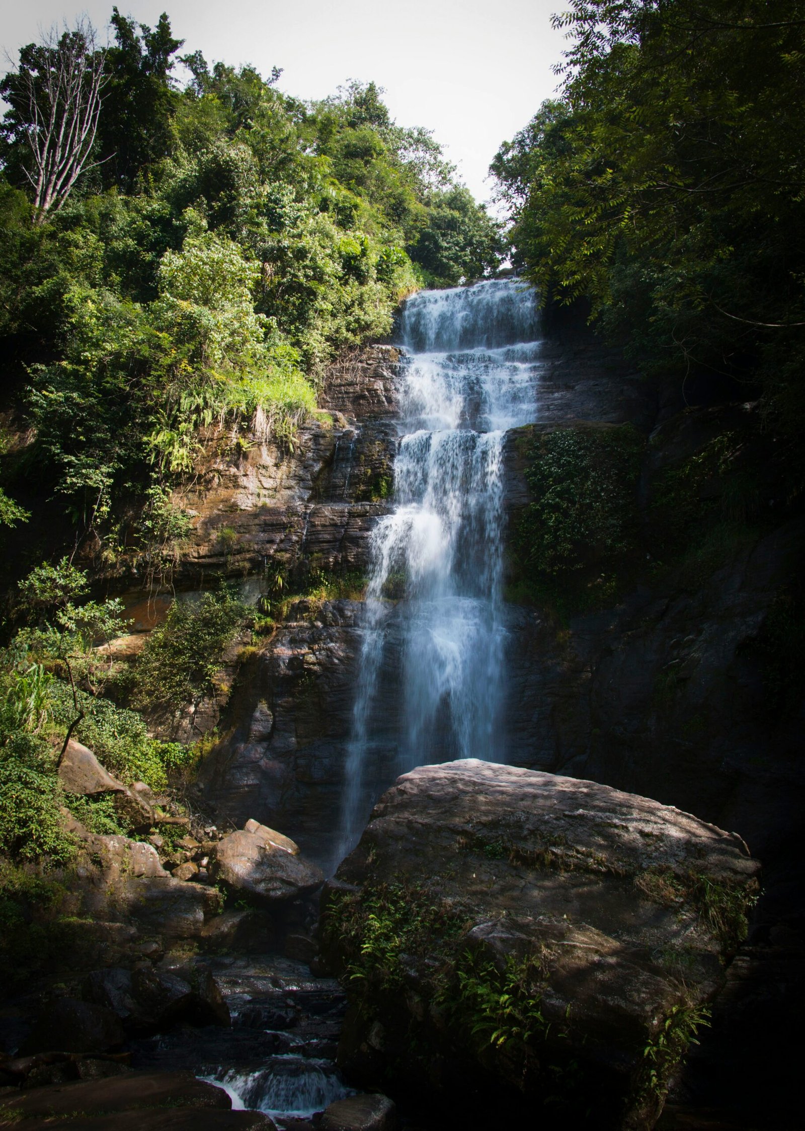 Jungle waterfall flowing through the lush scenery of Ratnapura, Sri Lanka.