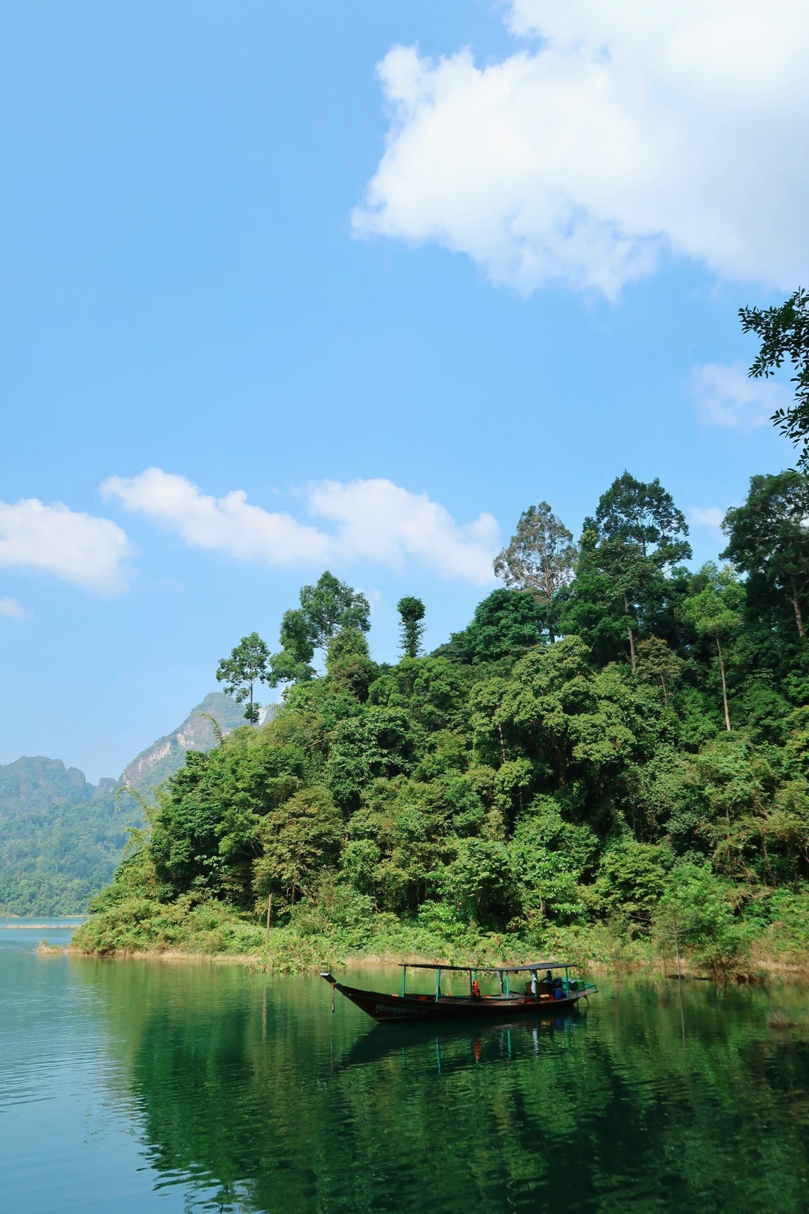 Boat on a forest lake in Khao Sok, Thailand, fitting a quiet retreat environment centered on renewal and metabolic balance.
