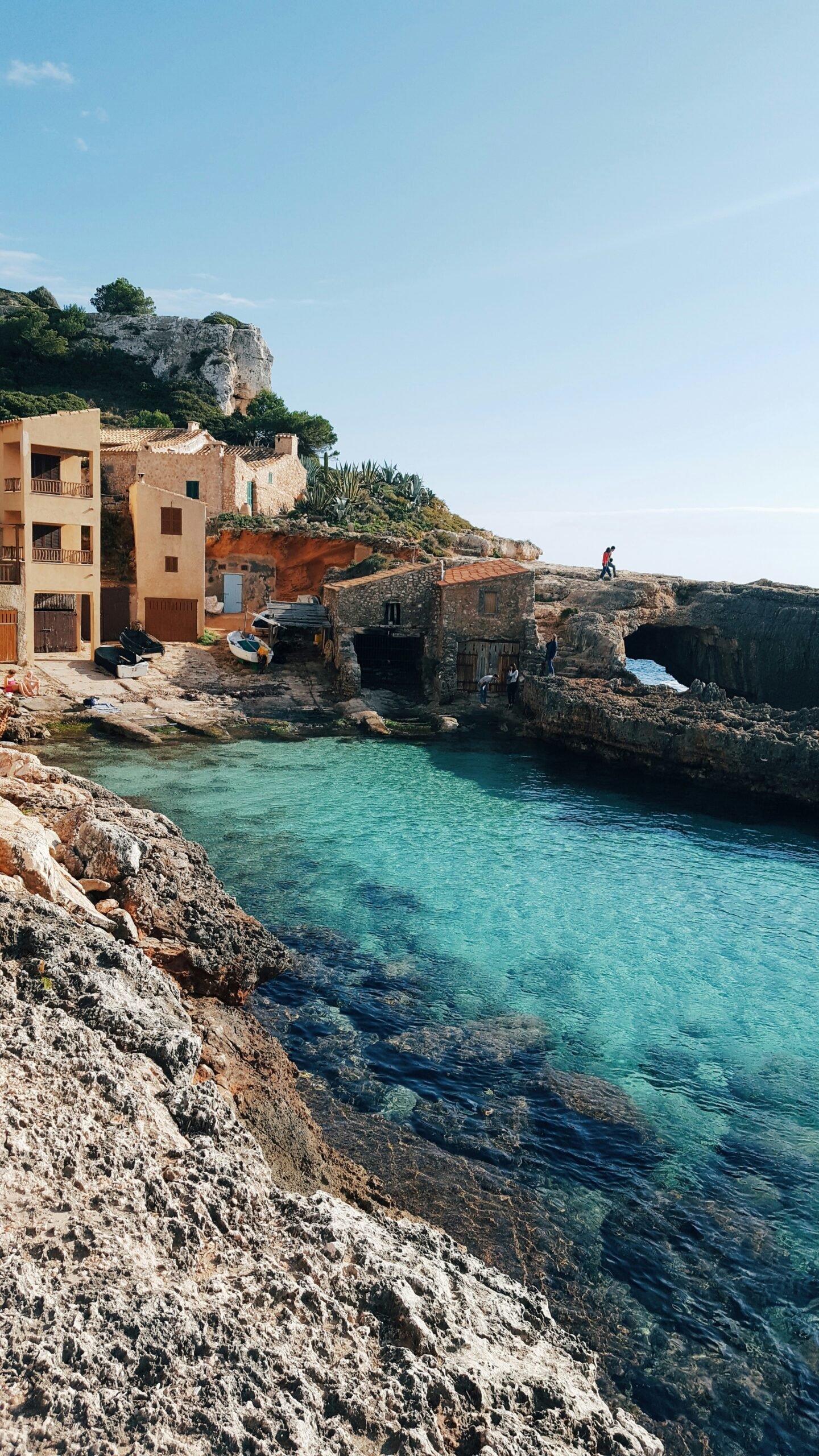Cala S'Almunia in Mallorca with rocky shoreline and intensely blue Mediterranean water.