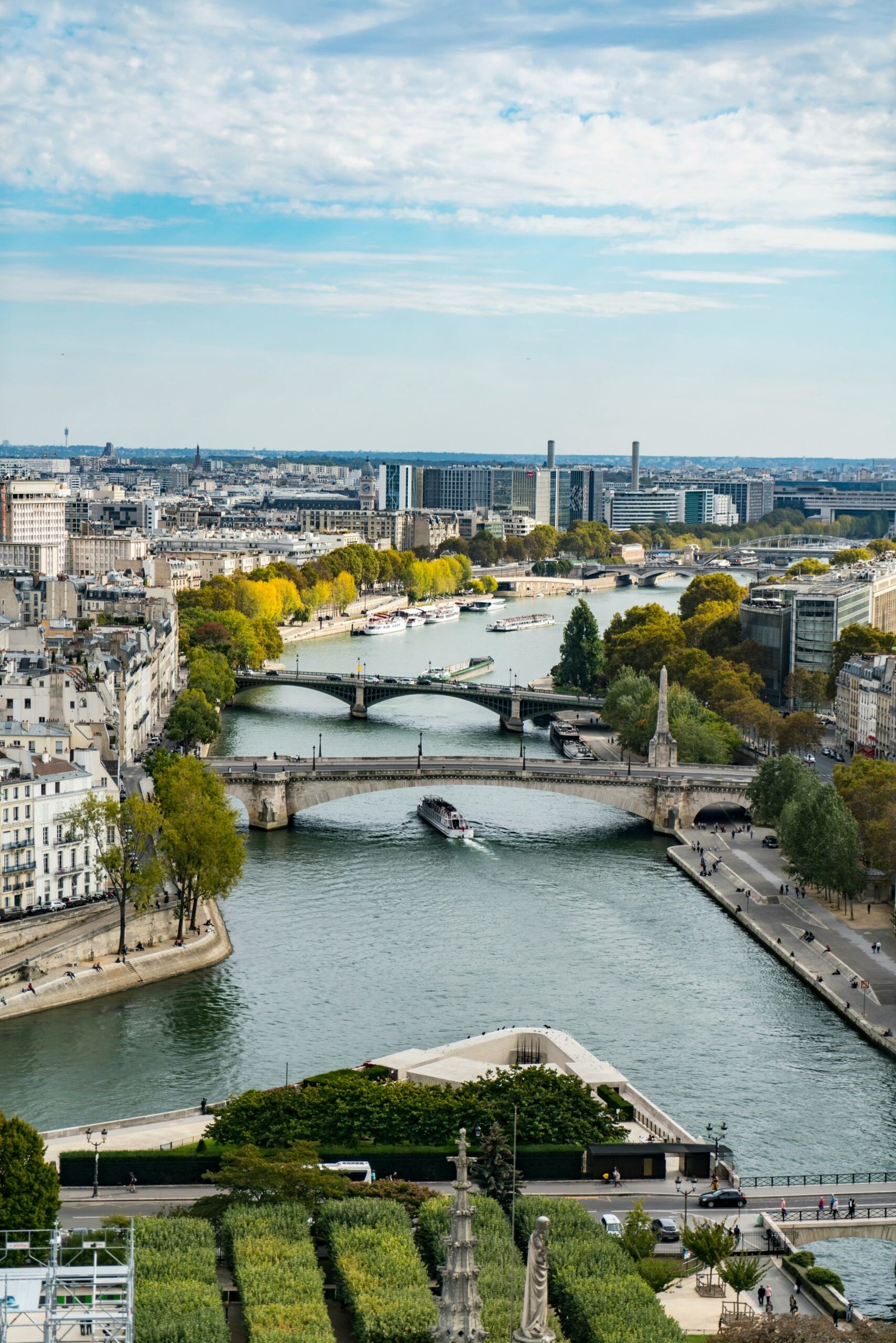 Aerial view of the Seine in Paris with bridge and river traffic, bringing a reflective city atmosphere to a France yoga retreat.