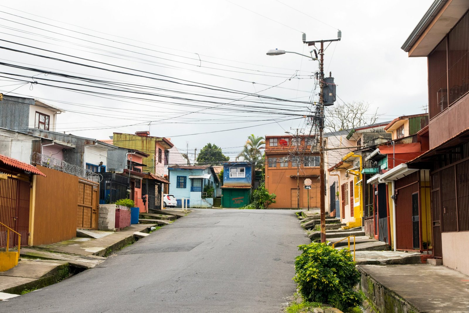 Neighborhood street with colorful hillside homes in San José, Costa Rica