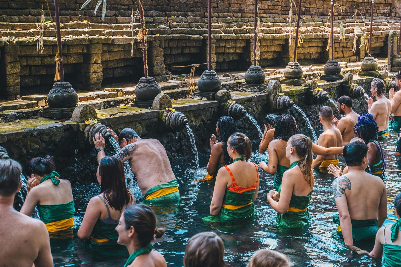 visitors taking part in purification at tirta empul holy spring in bali