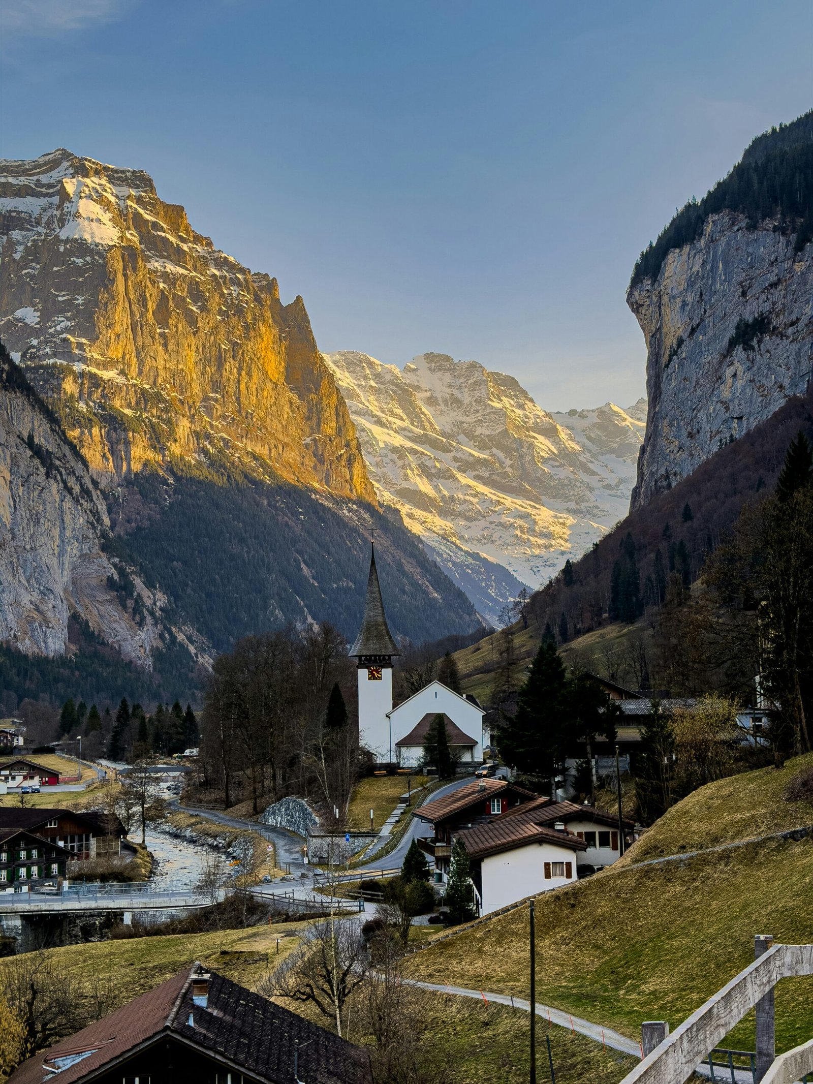 Lauterbrunnen village in Switzerland framed by snowy mountains and a quiet winter valley.