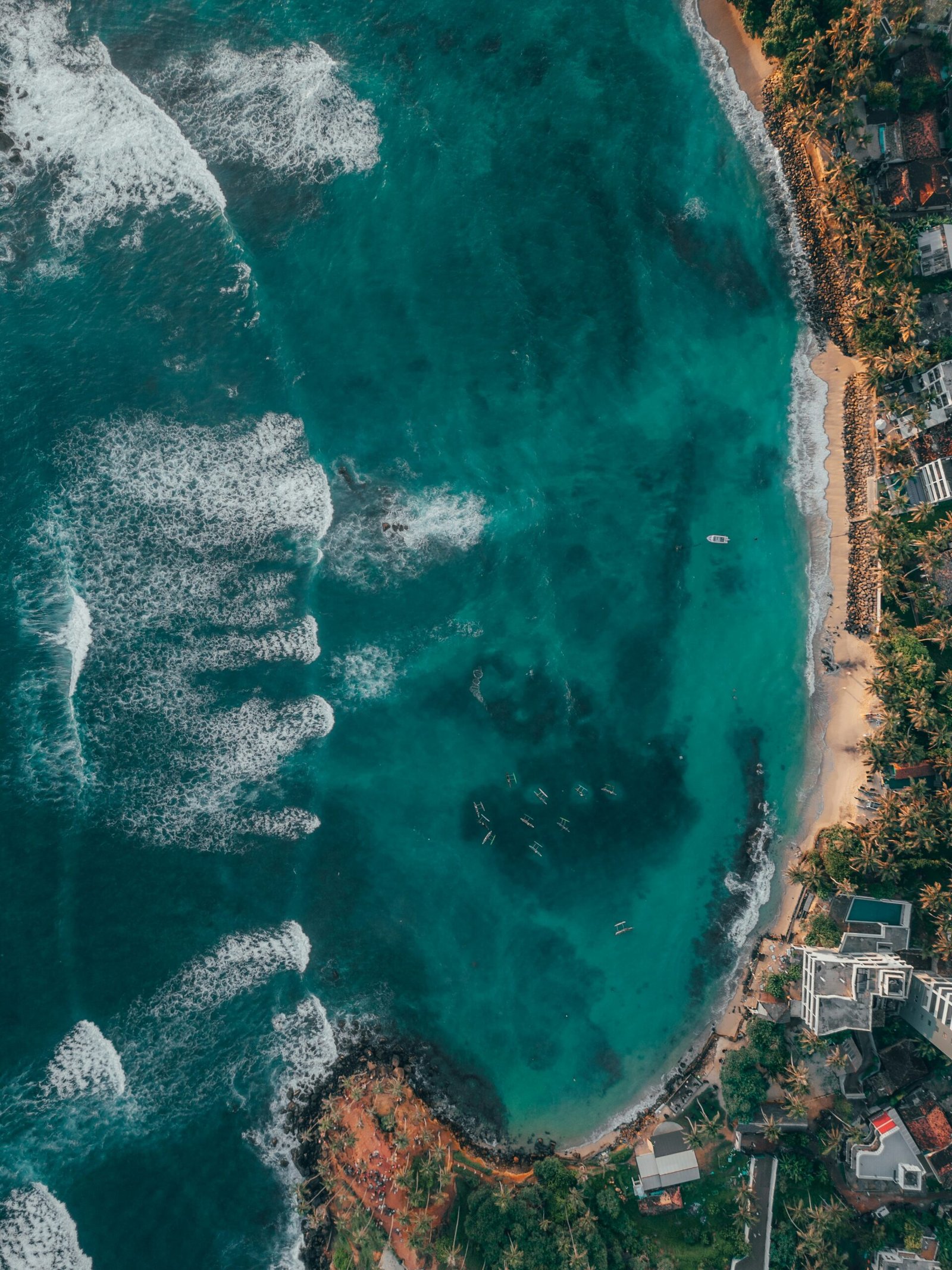 Aerial view of Mirissa Beach in Sri Lanka, matching the open and restorative feel of a seaside yoga retreat.