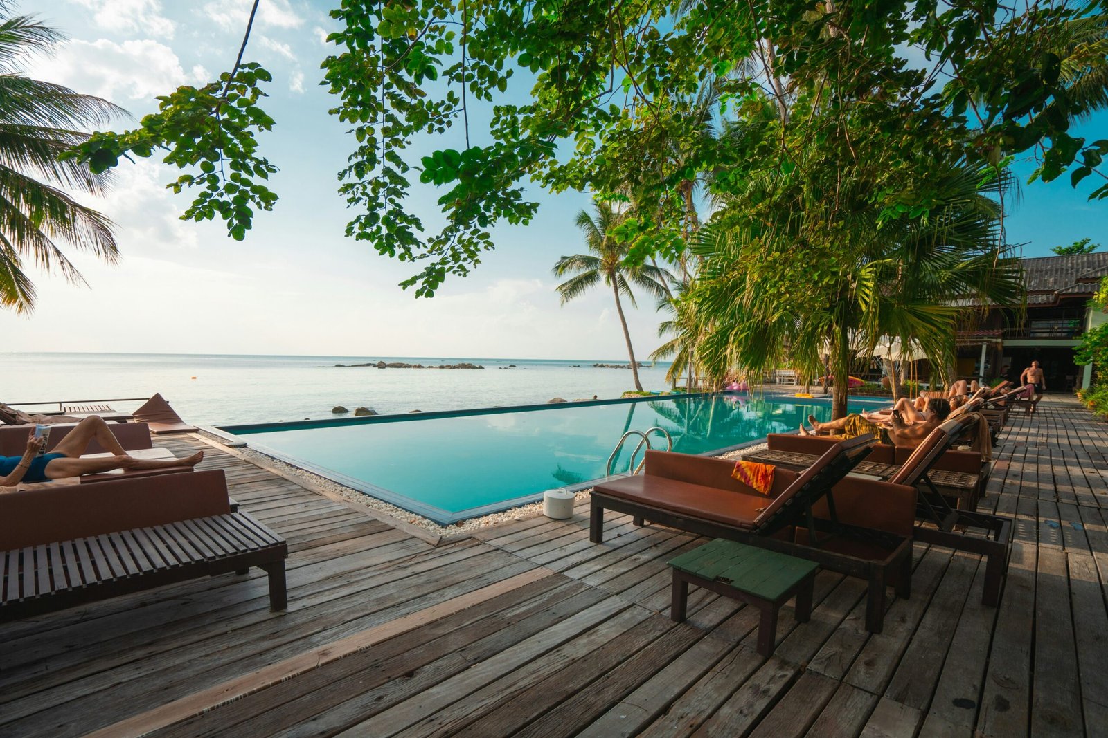 Peaceful tropical bungalow deck beside the water for a calming hydration-focused wellness retreat