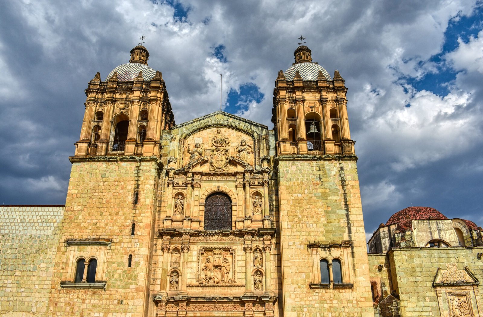 Cathedral in Oaxaca de Juárez under a cloudy sky, reflecting the cultural depth of a November retreat in Mexico.