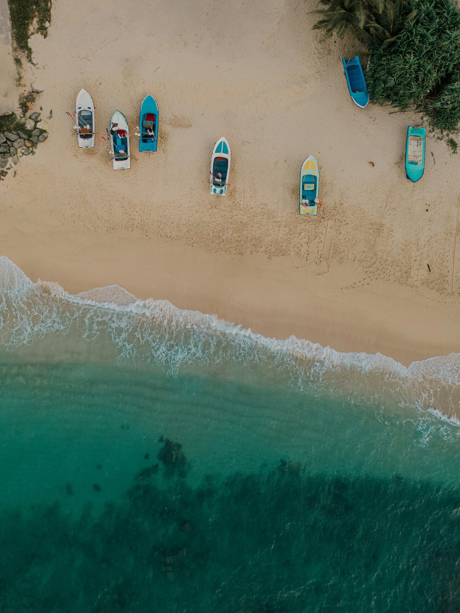 Boats lined along the shore in Hikkaduwa, Sri Lanka, bringing a grounded coastal feel to a December retreat itinerary.