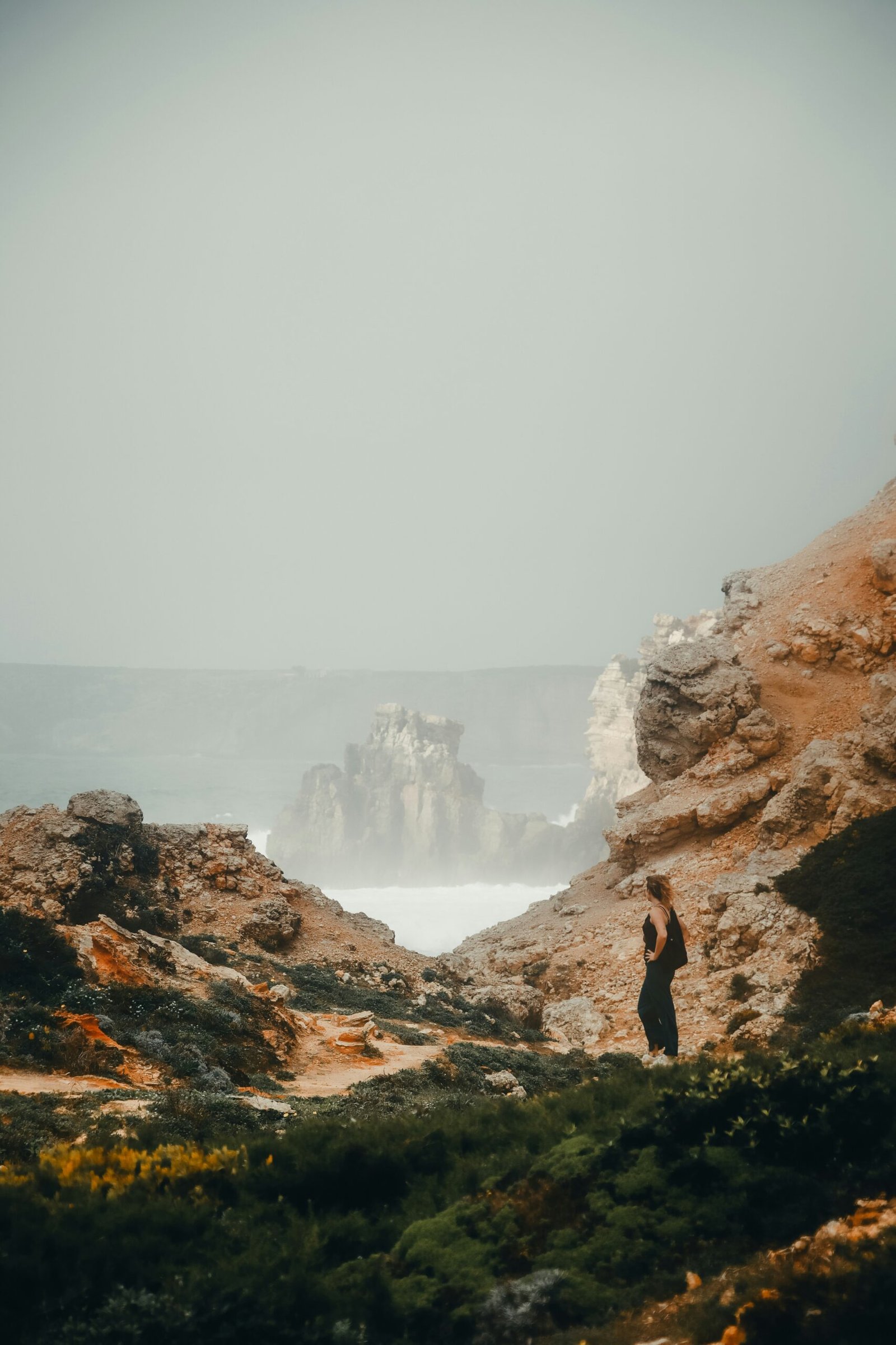 woman practicing yoga by the sea during a november wellness retreat in portugal