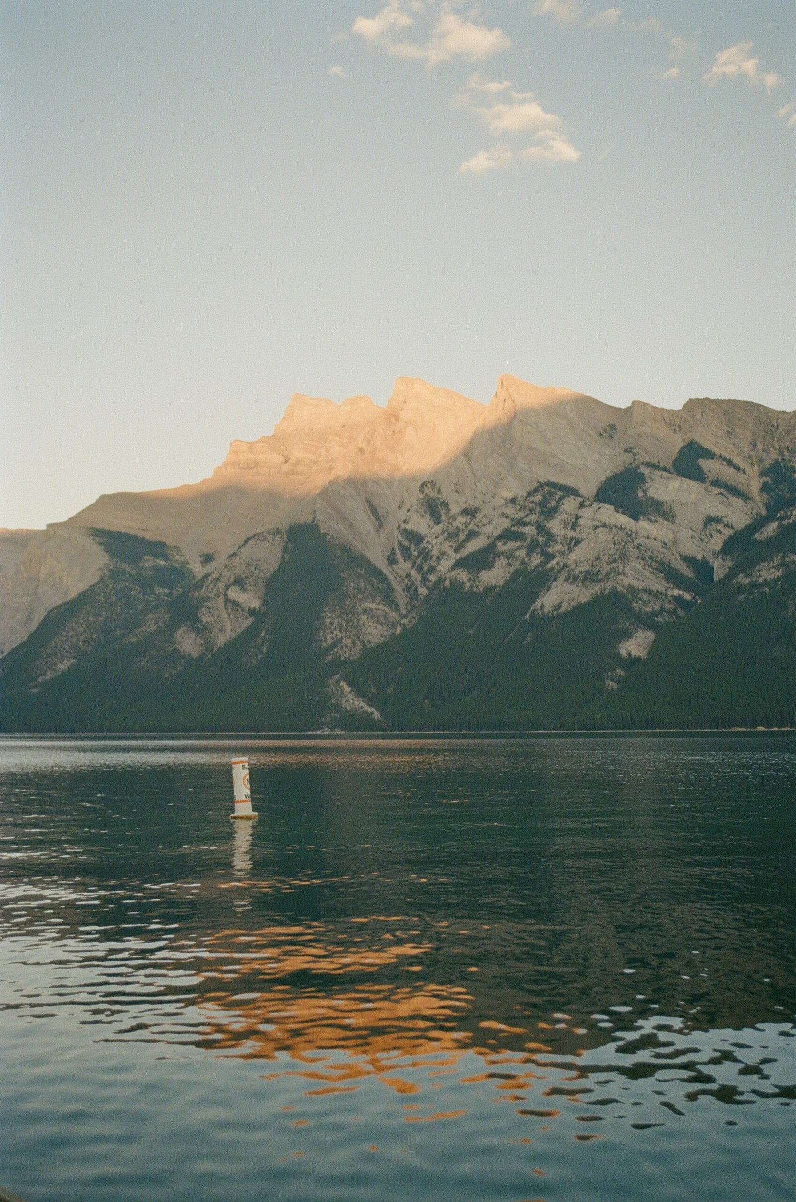 Banff lake and mountain range in Alberta, Canada, fitting a peaceful June retreat in a naturally cool and grounding landscape.