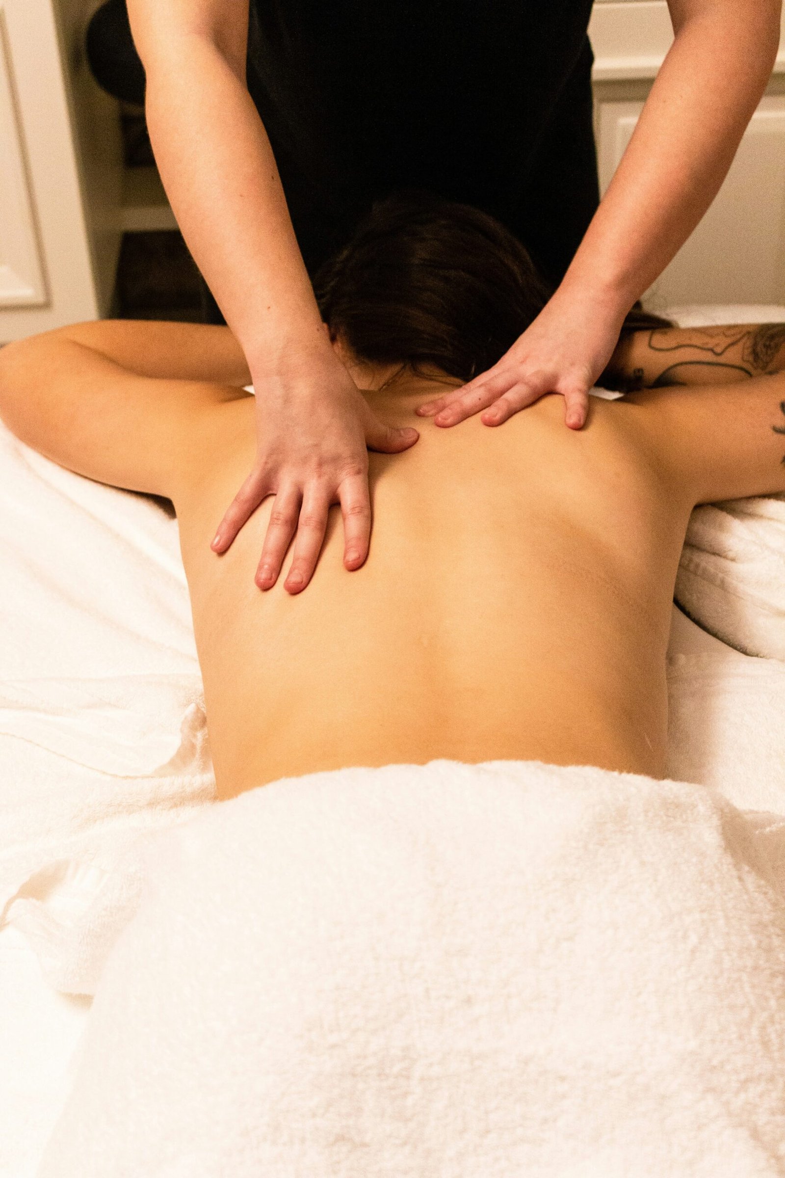 Woman receiving a back massage during a relaxing spa treatment.