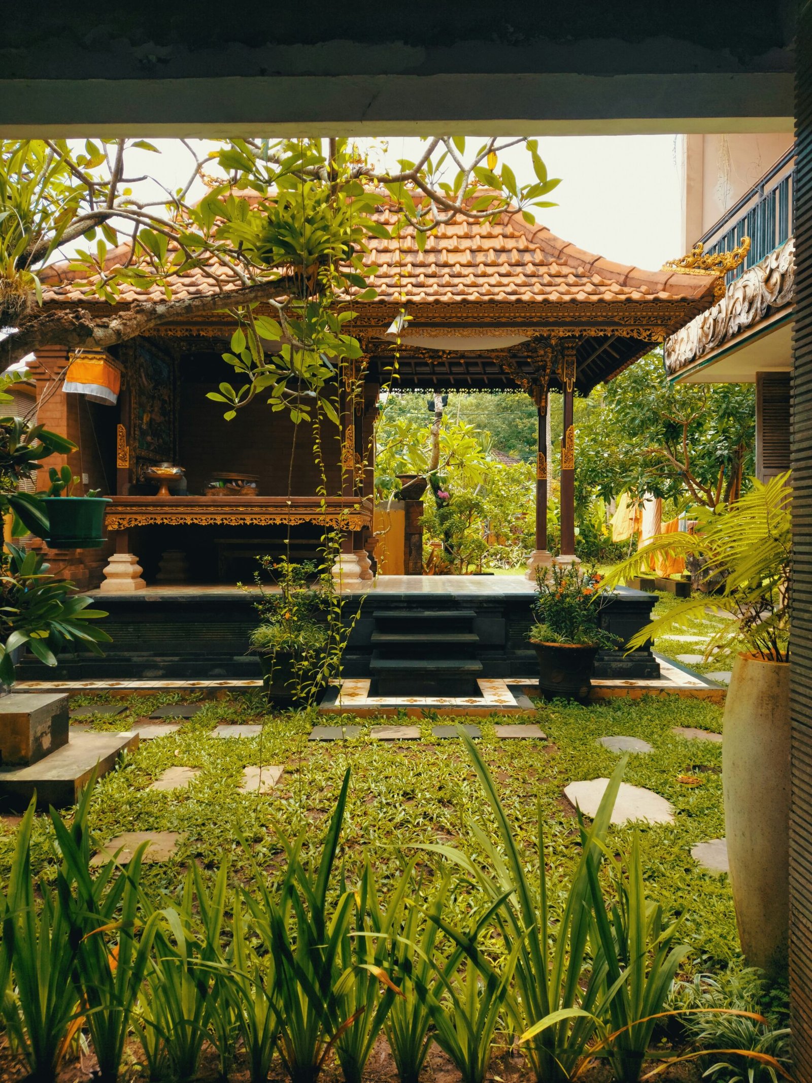 Garden gazebo with steps and greenery, matching the peaceful outdoor spaces often found at a wellness retreat.