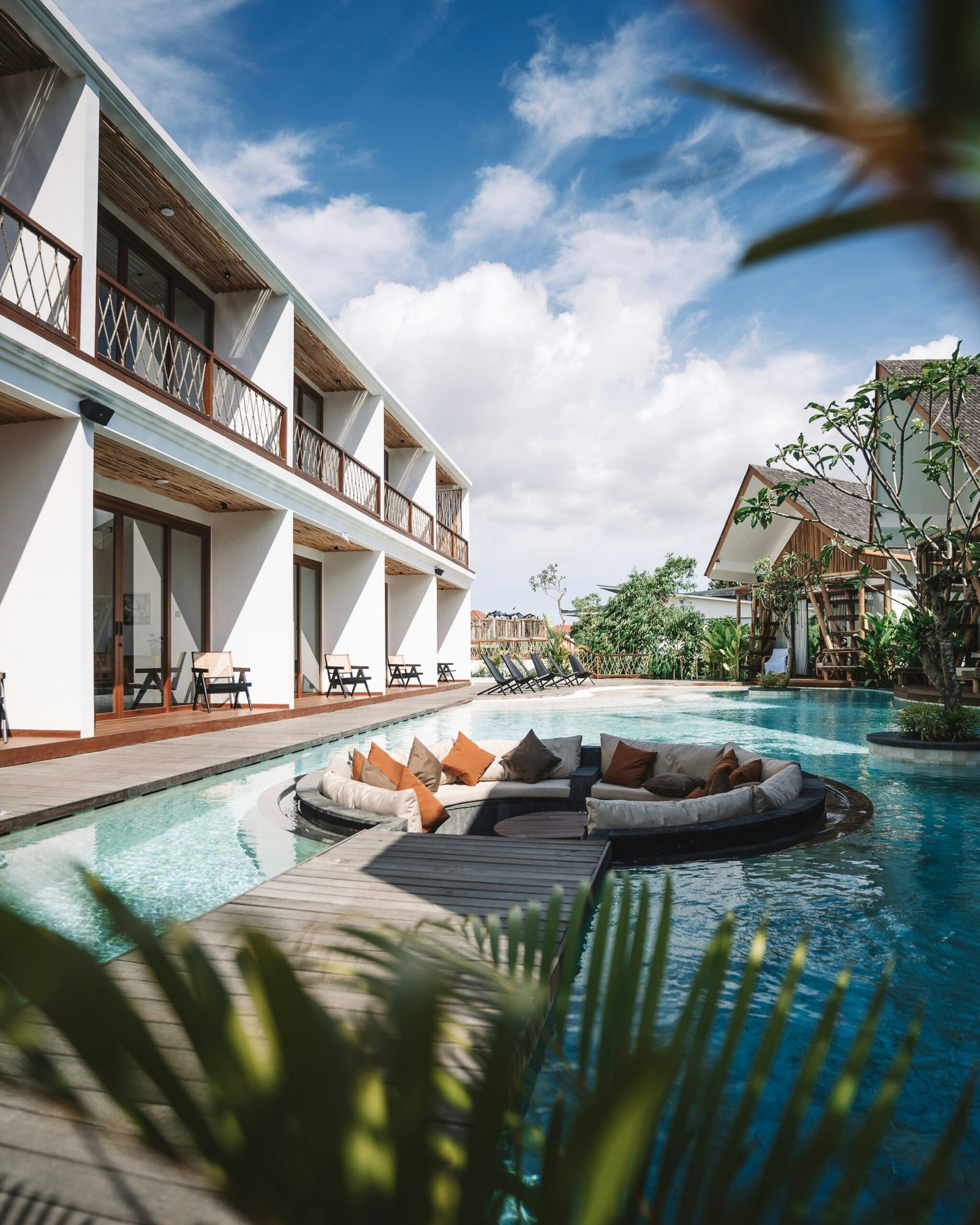 Spacious retreat hotel pool with lounge chairs for a restful wellness stay
