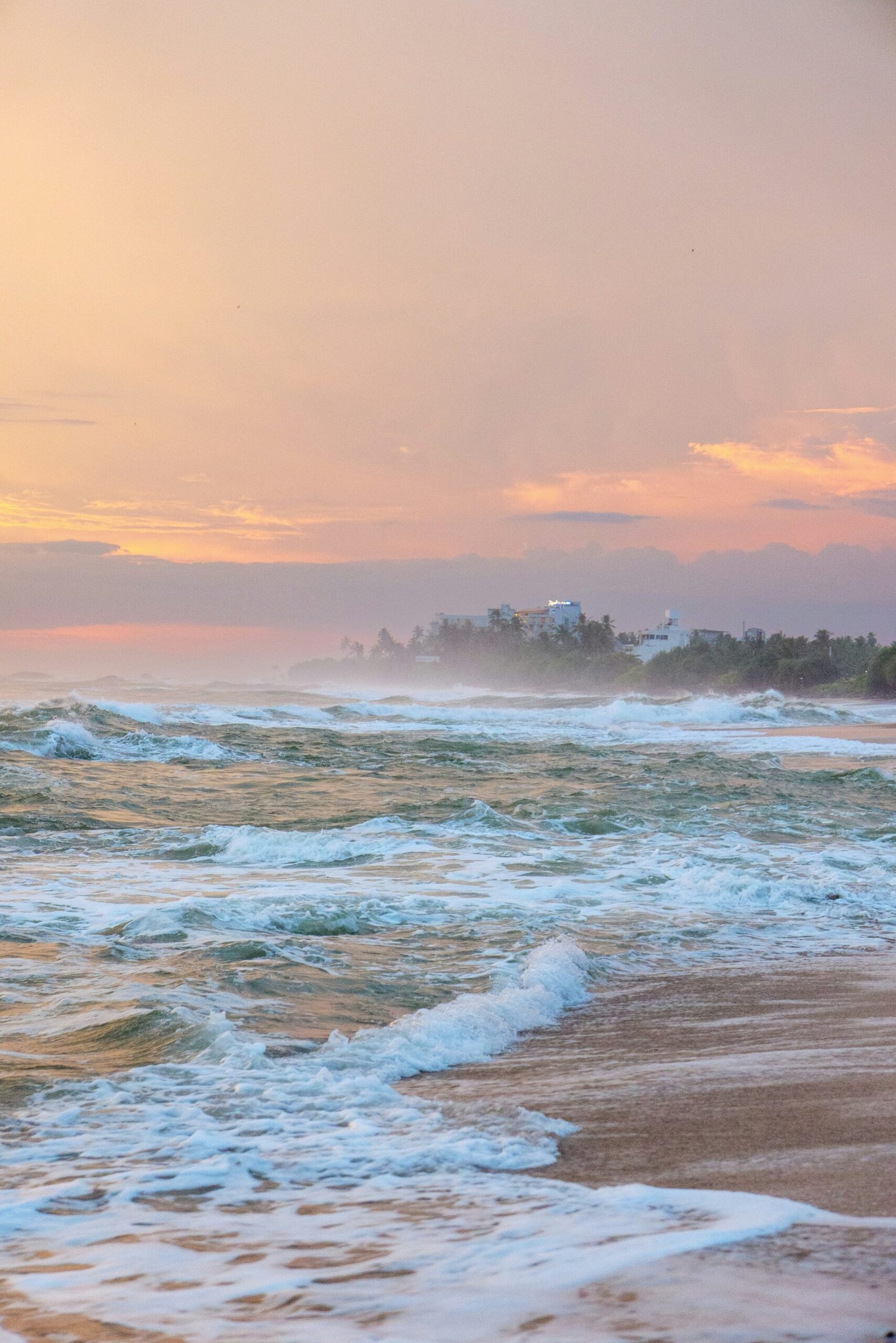 Sunrise waves rolling onto the shore for a refreshing retreat atmosphere centered on clarity and quiet reset