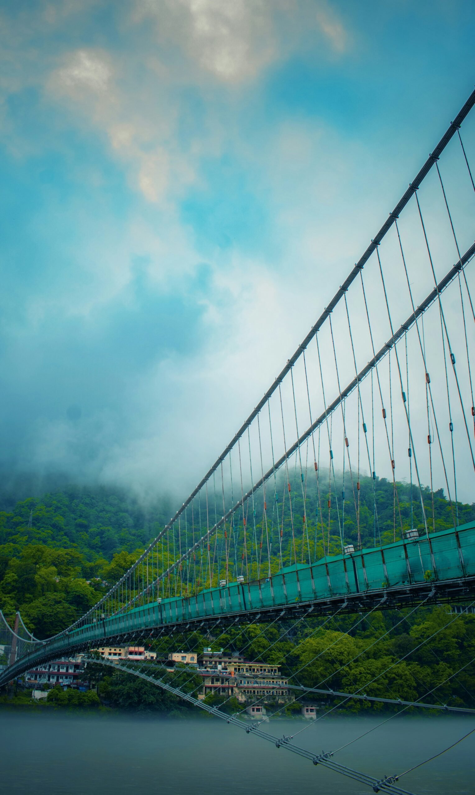 Laxman Jhula rising over the river in Rishikesh, matching the spiritual focus and movement of an October retreat in northern India.