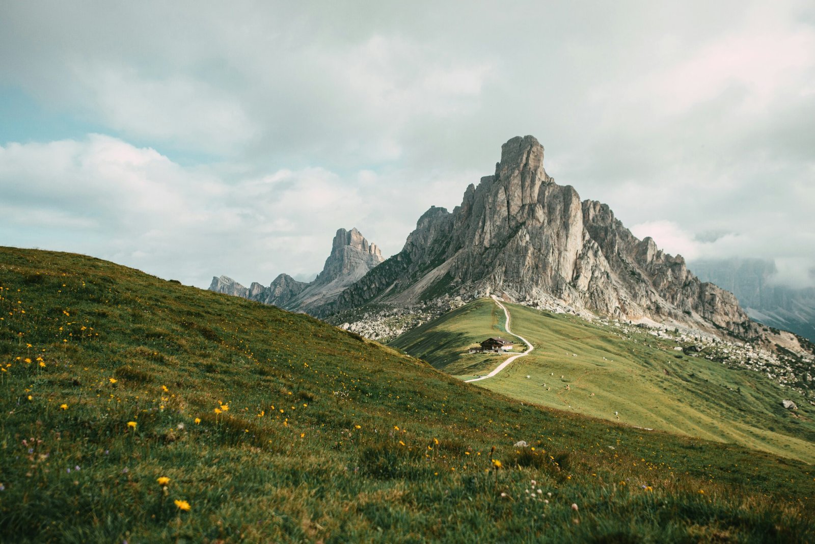 Winding mountain road at Giau Pass in the Italian Dolomites with sweeping open views.