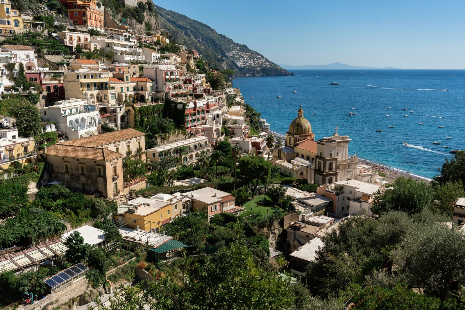 Positano rising above the sea on the Amalfi Coast with layered pastel buildings and cliffside charm.