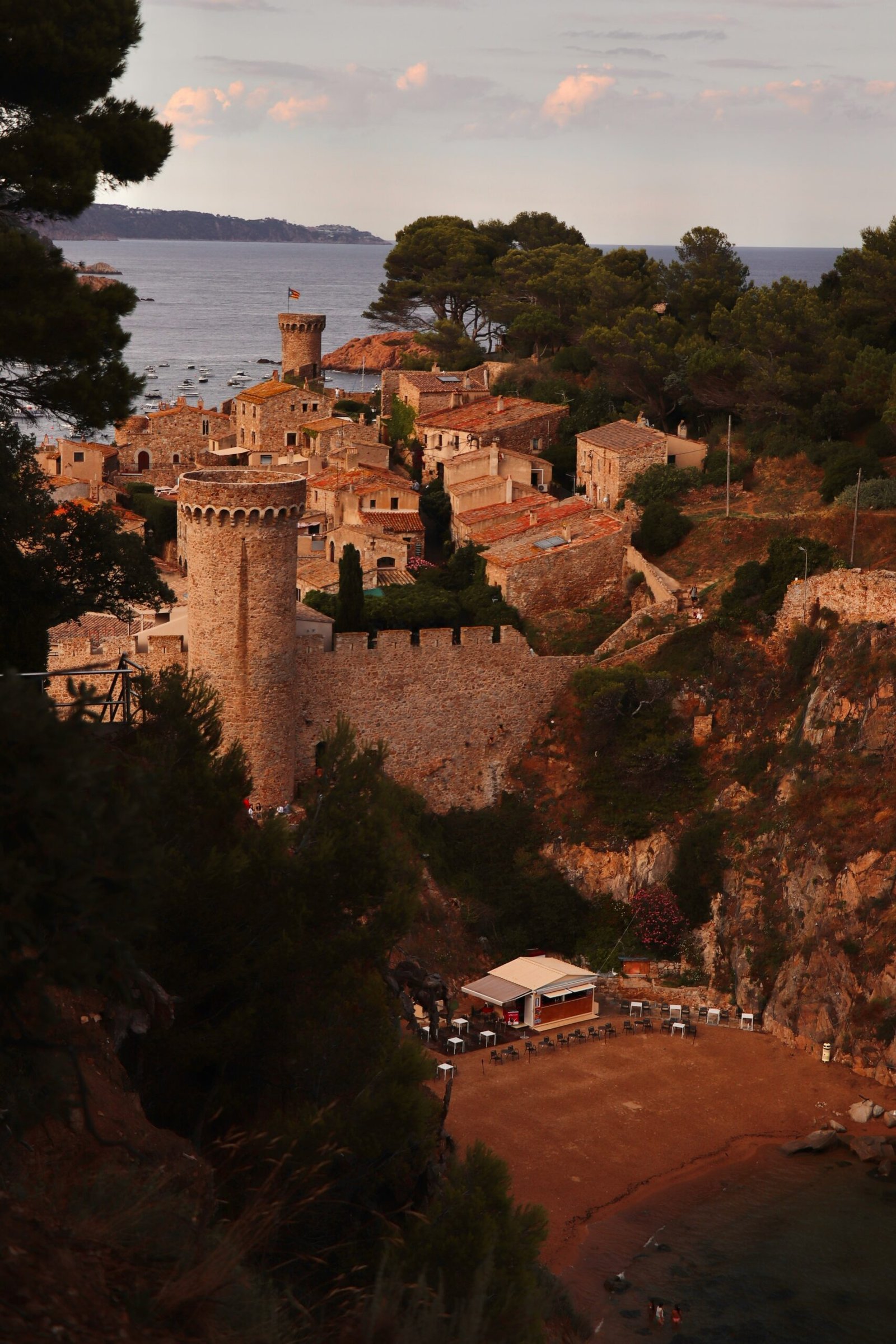 Historic coastal village of Tossa de Mar in Catalonia, Spain, with stone buildings above a Mediterranean cove